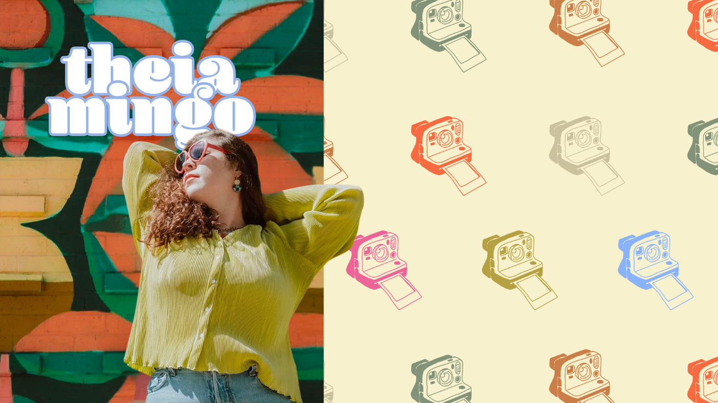 A woman with curly hair, wearing sunglasses and a green blouse, leaning back with her hands behind her head against a colorful graffiti wall that says 'theia muro'.