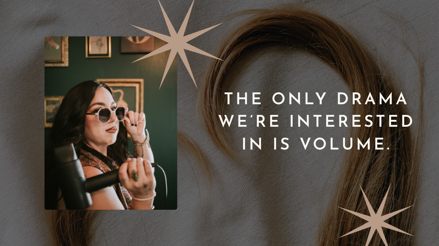 A woman with dark hair wearing sunglasses, holding a curling iron, in a vintage-style room with framed pictures, and a quote on the background about volume.