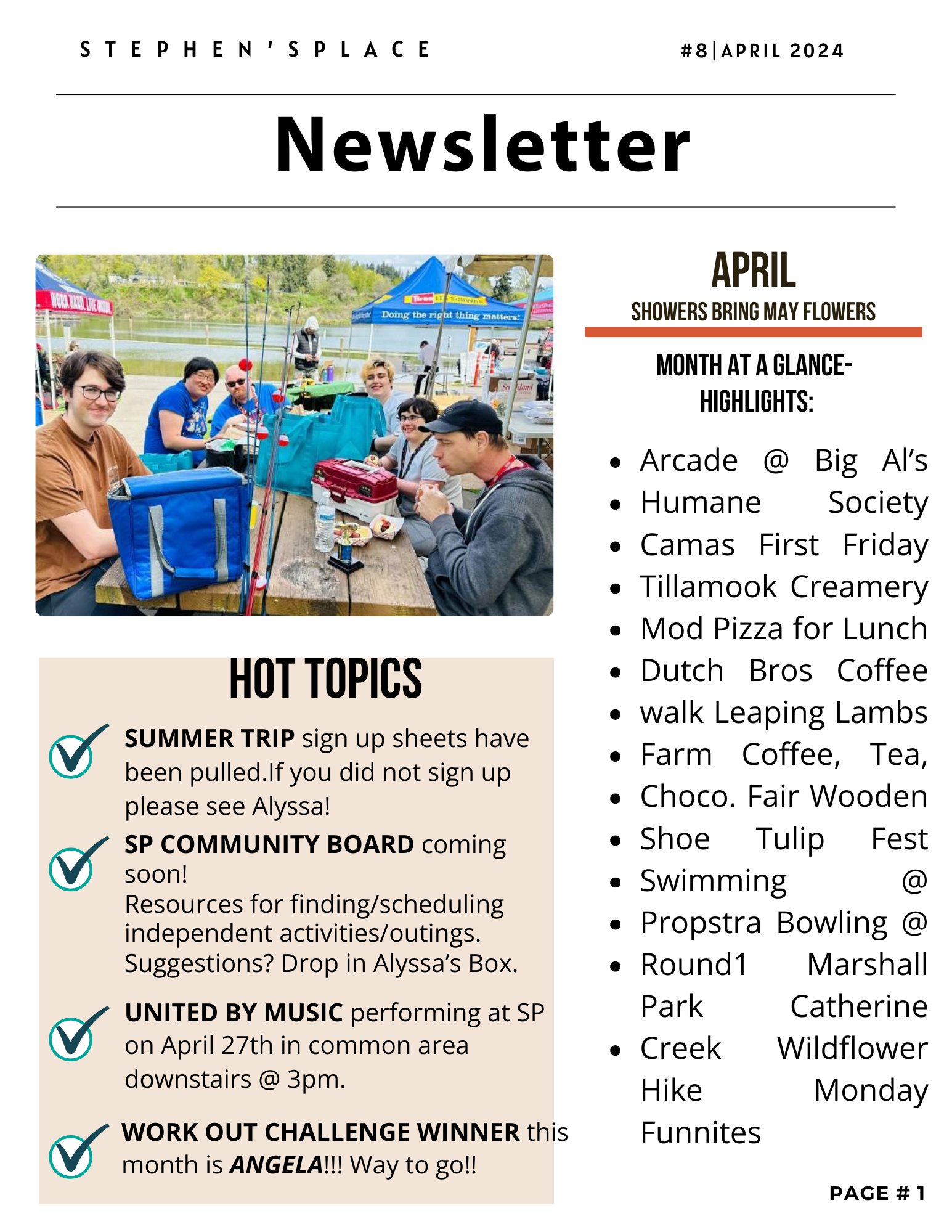 A group of people sitting at a picnic table outdoors near a lake, with tents and trees in the background, enjoying a day together.