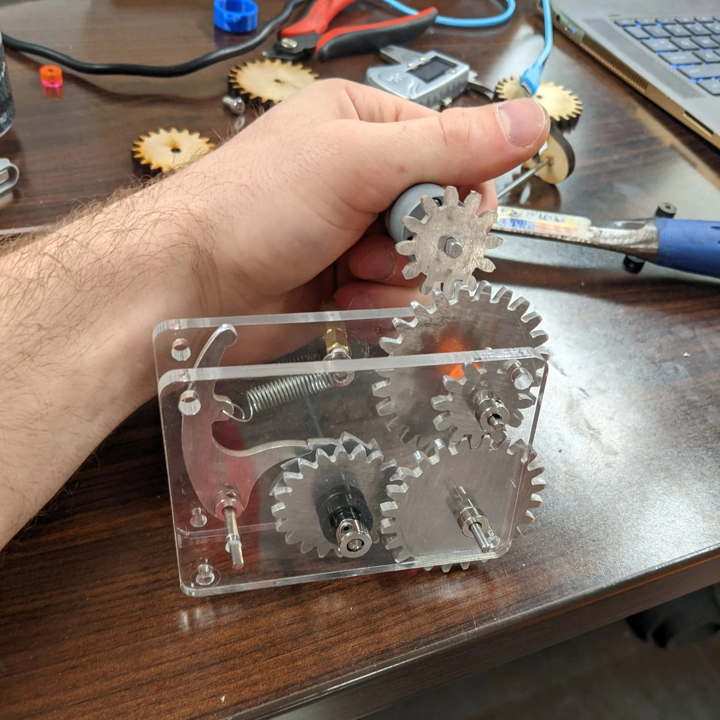 As a first project on our makerspace's new Wazer waterjet, I designed and fabricated an intermittent ratcheting gearbox from scrap aluminum. This allowed the launcher to be loaded under the power of a 24V DC motor and fired by releasing the pawl with