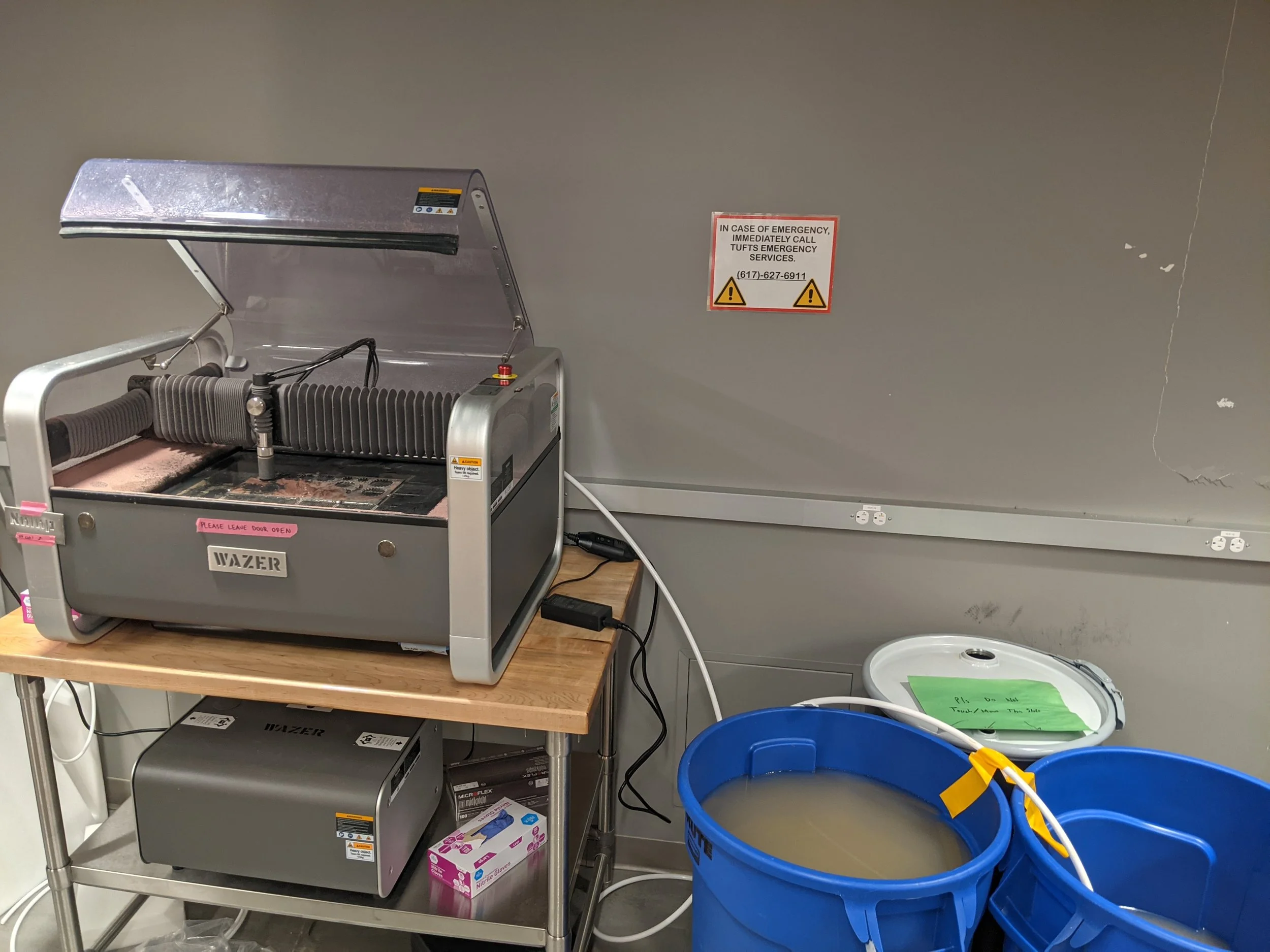 The aforementioned new Wazer desktop waterjet we had just obtained for the makerspace, as well as our janky wastewater setup
