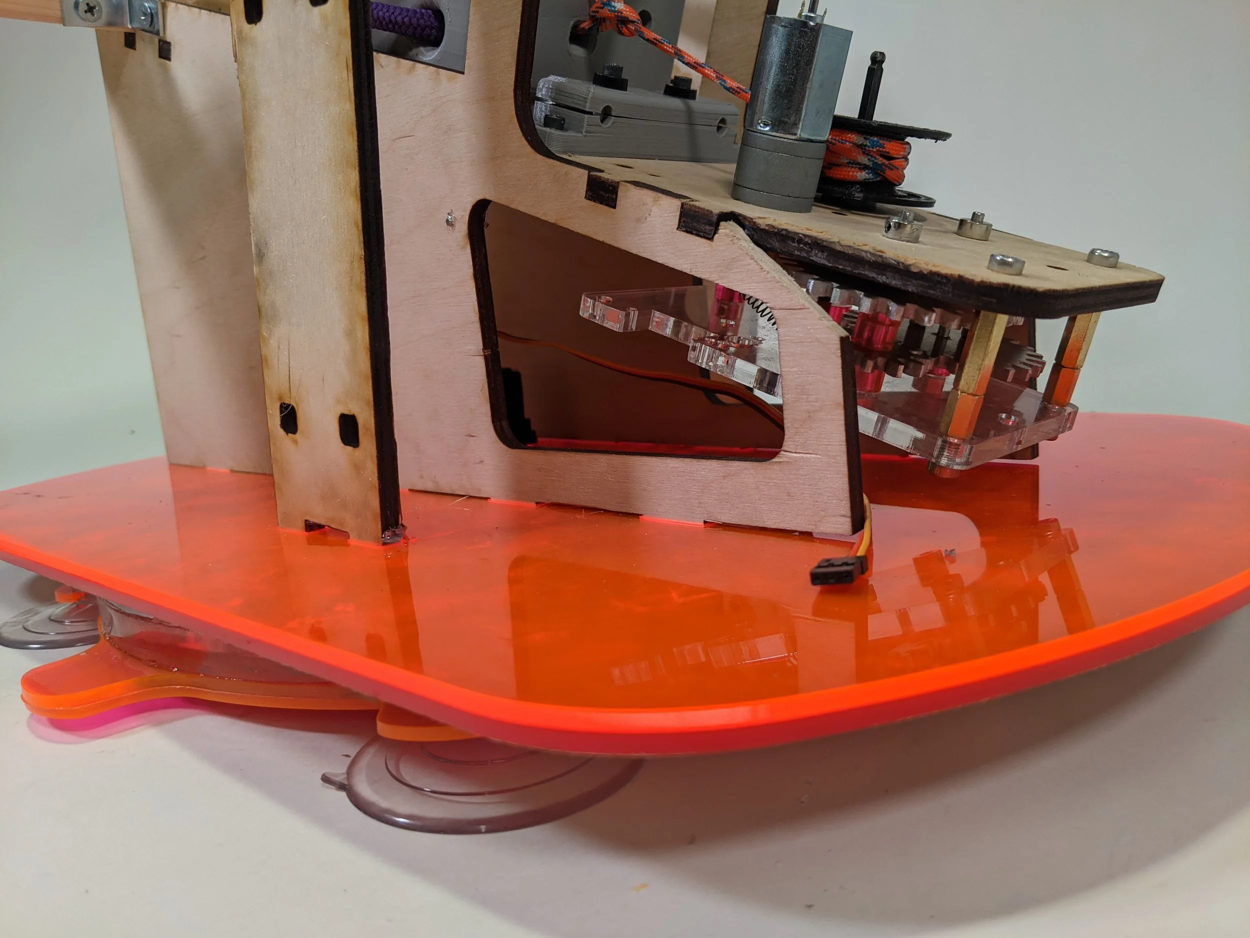 A slightly less obfuscated look at the laser-cut acrylic base, which could be secured to a table using suction cups and be driven to a specific yaw by a 360-degree servo