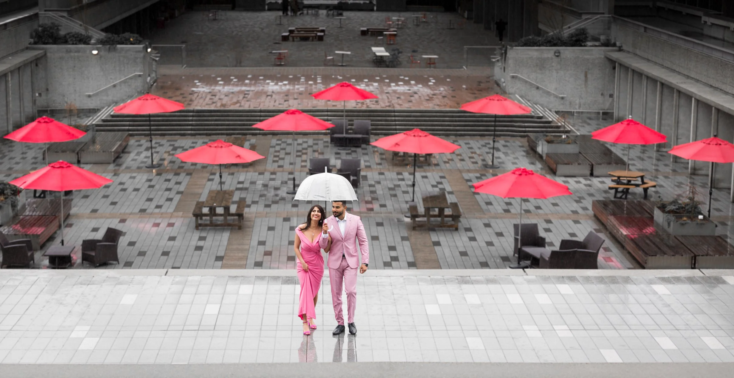Mountain range at sunset with grassy foreground and clear sky.