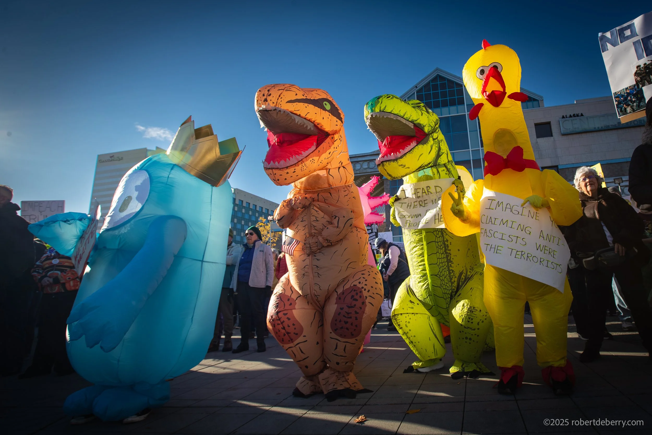 People dressed as dinosaurs for No Kings Protest