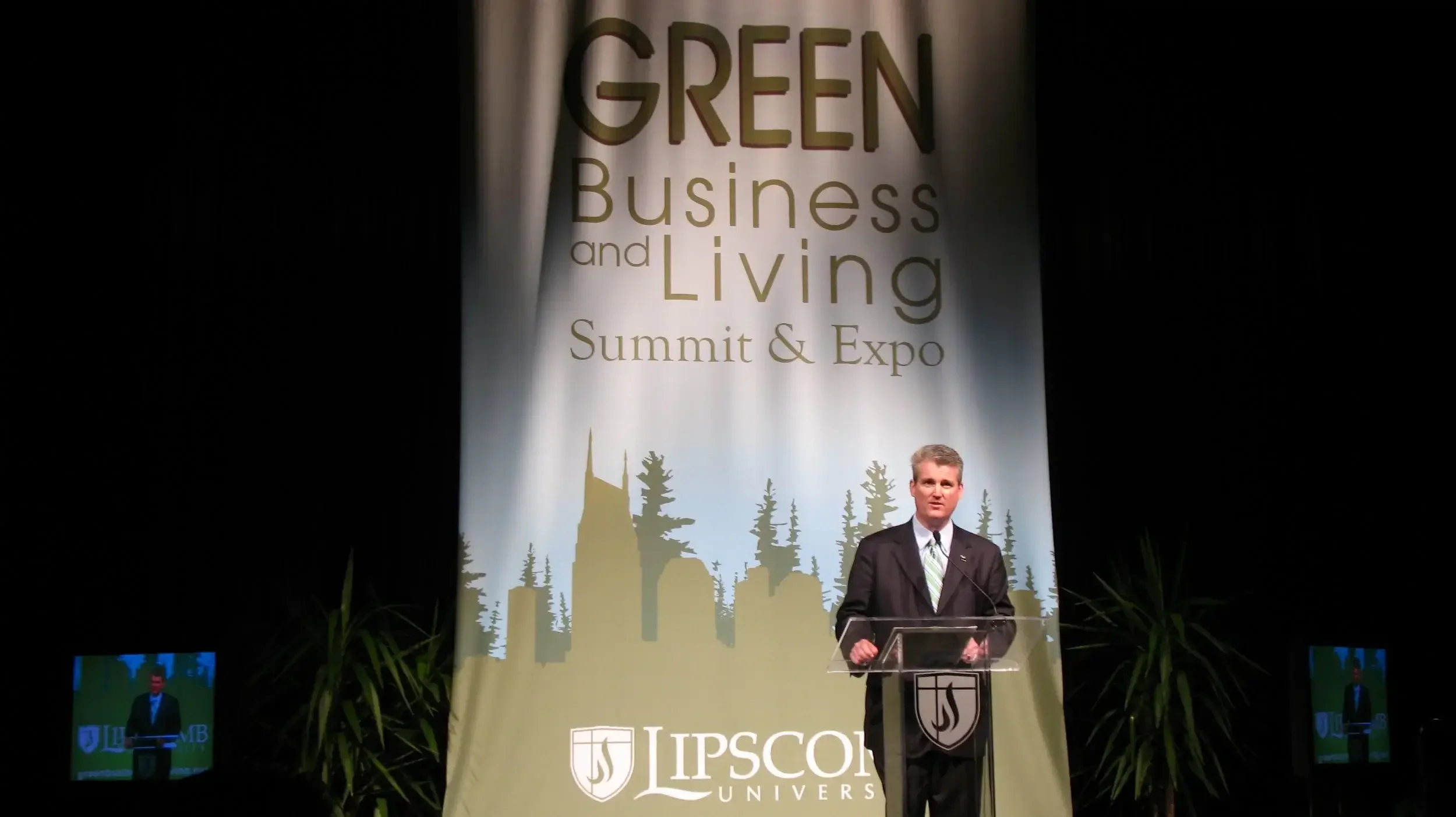 Emcee welcoming attendees of the Green Business and Living Summit & Expo at Lipscomb University.