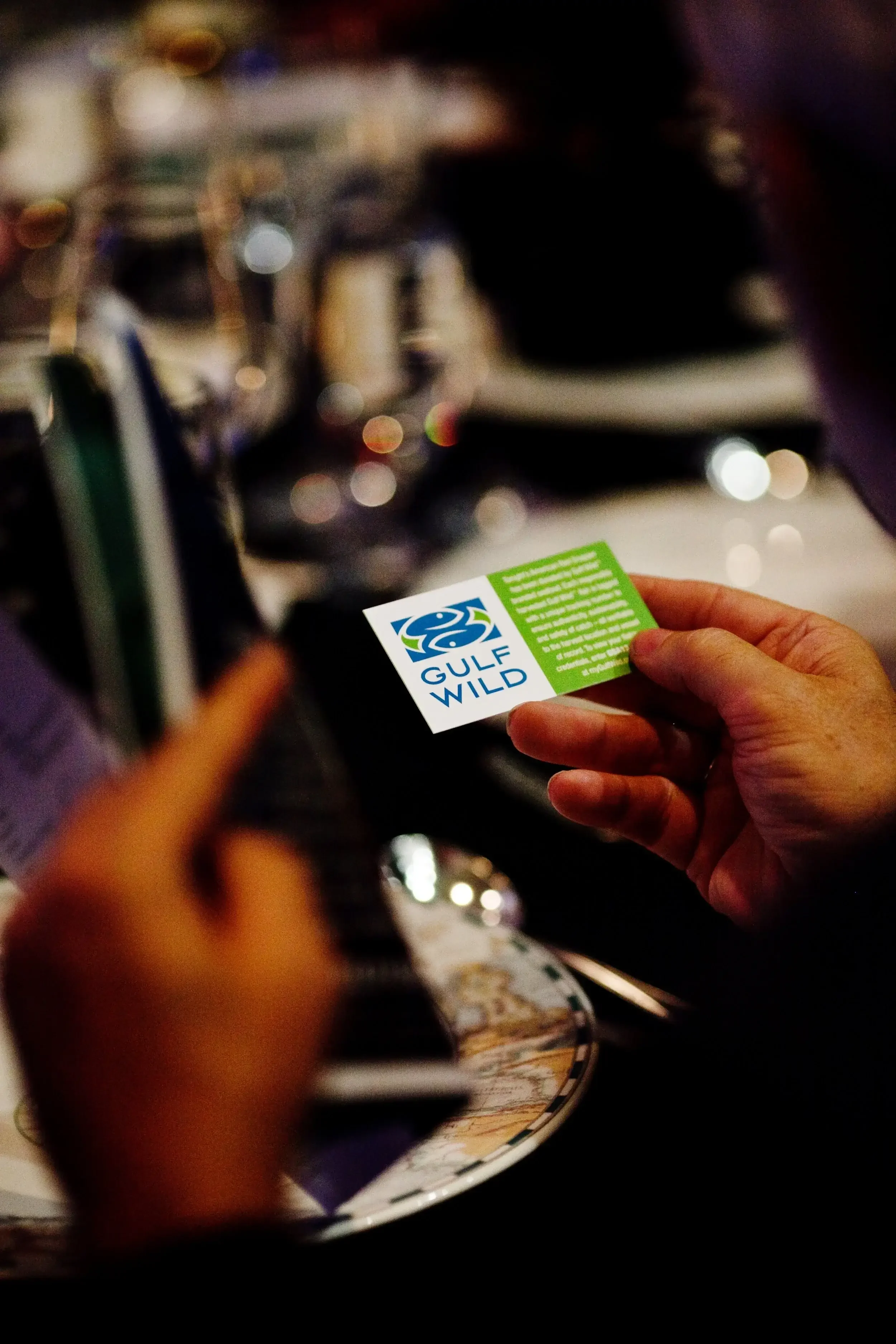 Close-up of a Gulf Wild card with logo against a blurred background.