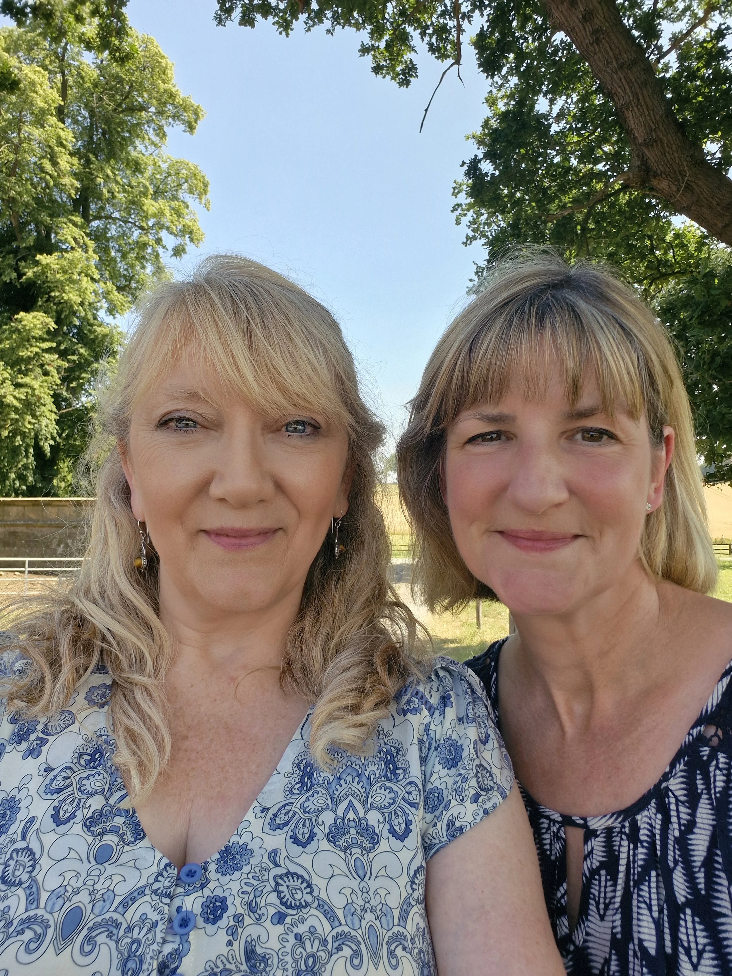 two women in nature smiling