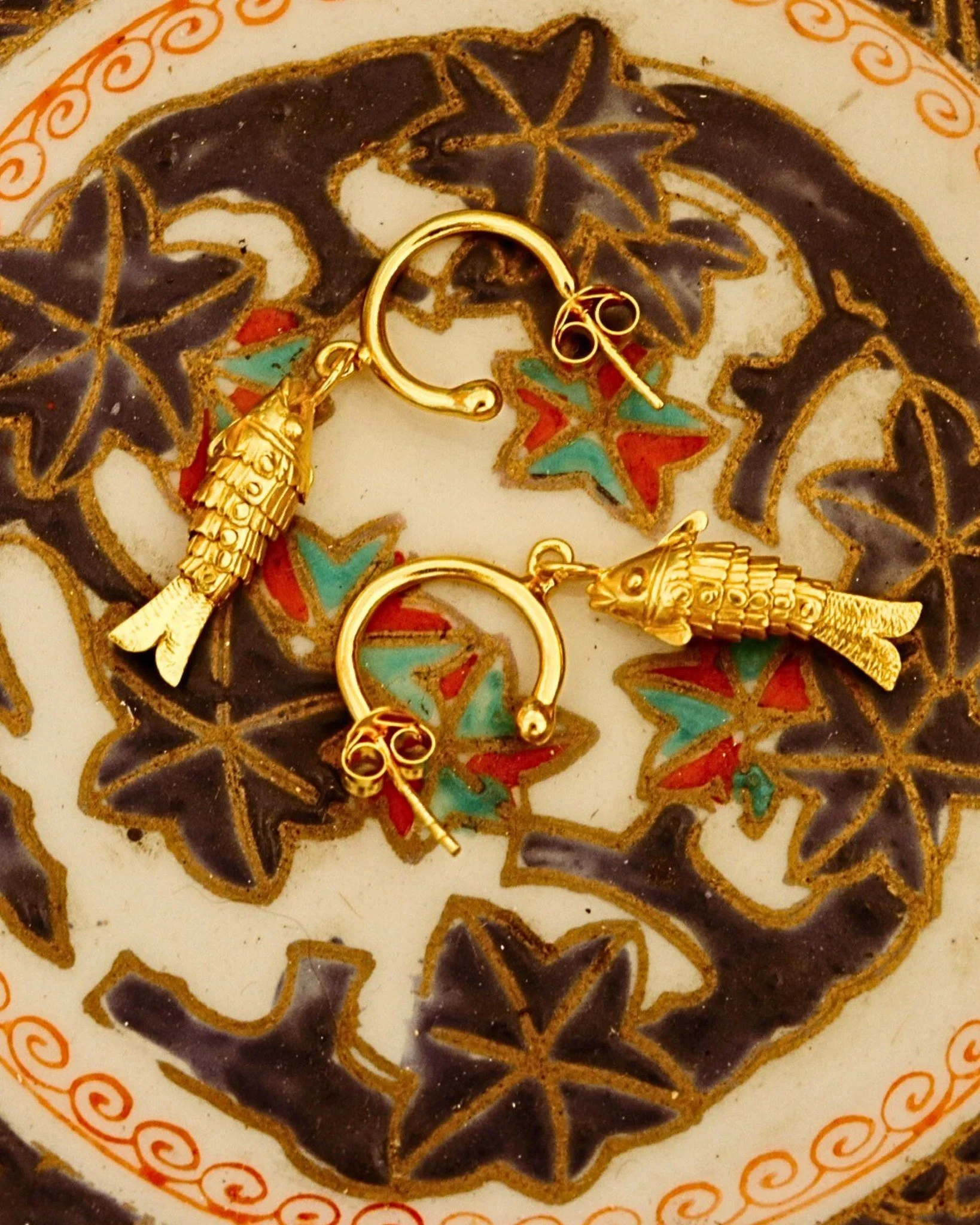 The mythological Ikhthyes were two large Syrian river fish who rescued Aphrodite and Eros from the monstrous Typhoeus. Feel a little braver with Sally&rsquo;s charming protective talisman earrings. 
.
.
.
 #greekmythology #mythology #fishearrings #ea