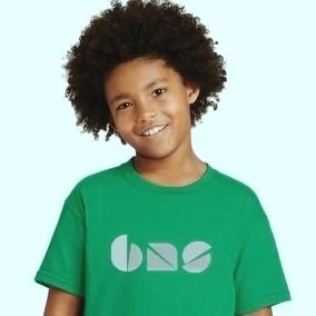 Kid modeling a tee shirt with the BNS logo