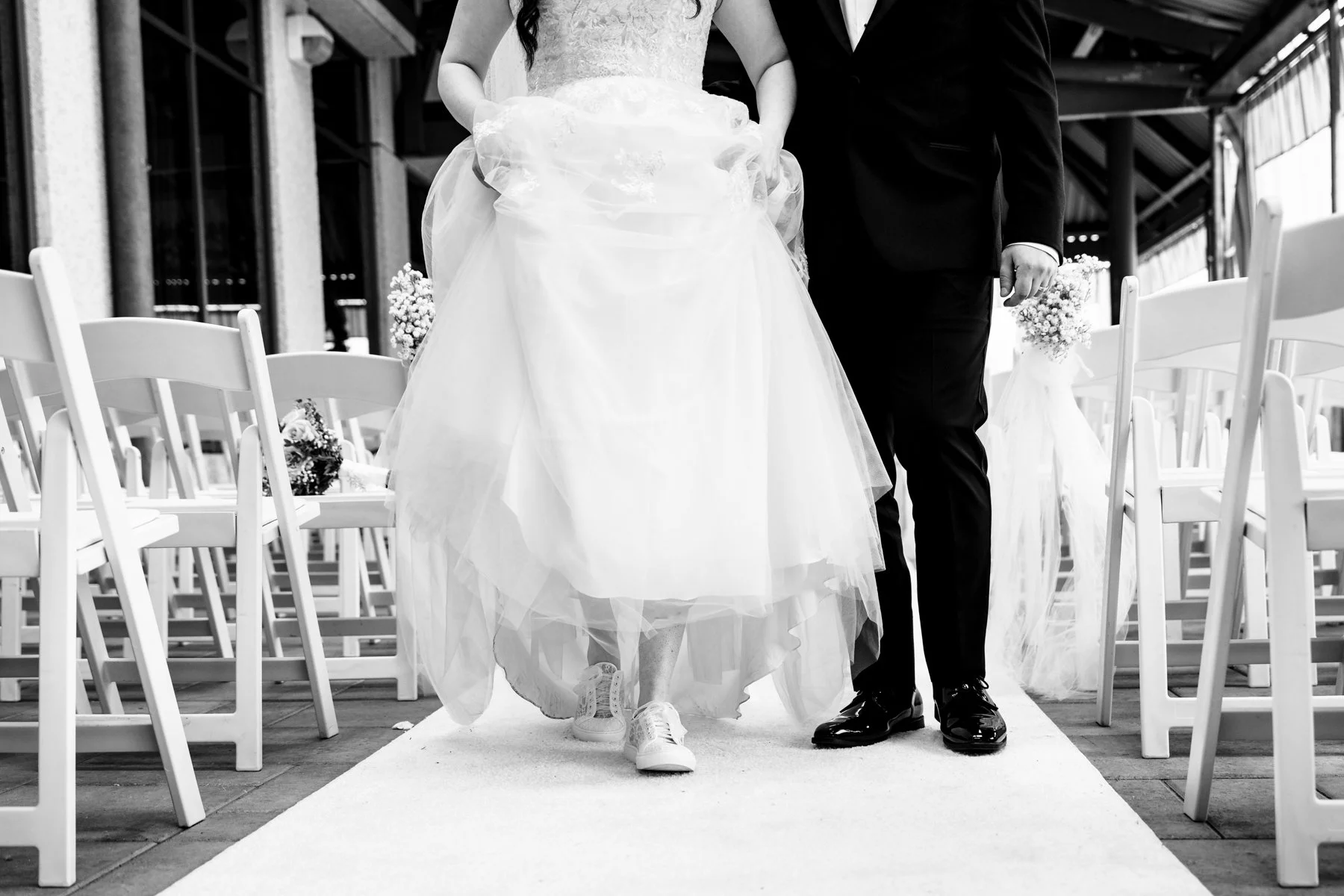 Bride and groom walking down the aisle after their Montreal wedding ceremony, captured in a candid documentary style.