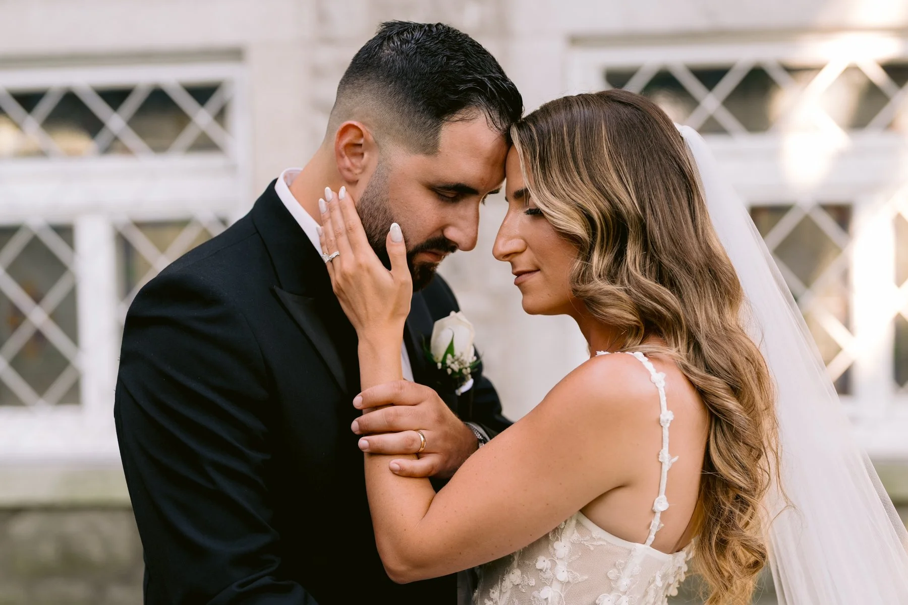 Newlywed couple sharing an intimate moment during their couple photo session after their wedding at St. George Greek Orthodox Cathedral
