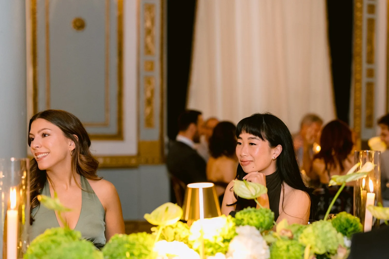 Wedding guests enjoying speeches during an elegant reception at Le Windsor in Montreal with candlelit tables and floral décor.