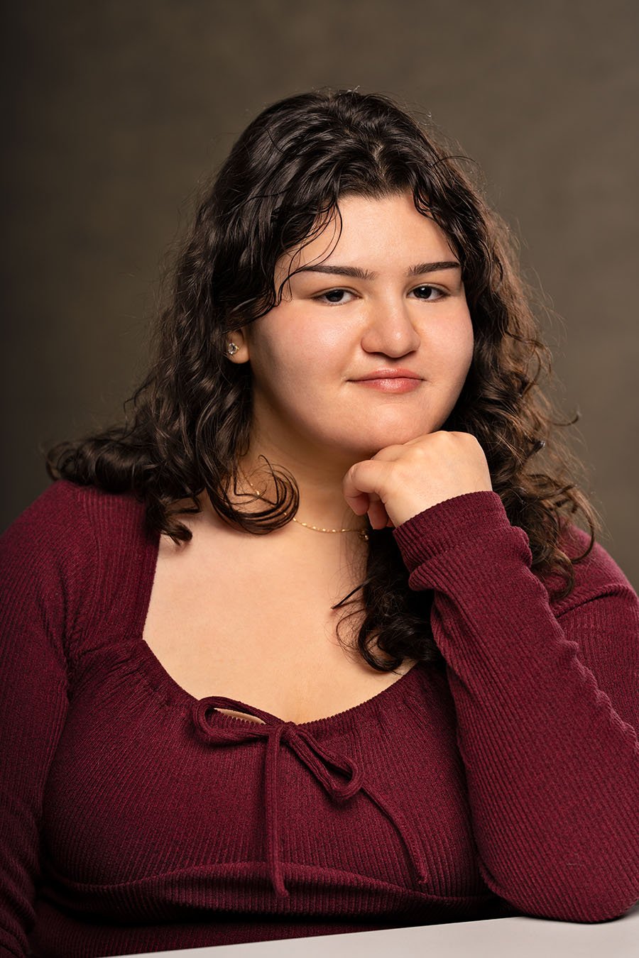 Photographed by Karishma Pageau, a Montreal headshot photographer, this professional portrait features a poised aspiring actress, captured with soft, controlled studio lighting, creating a natural and approachable expression ideal for casting submiss