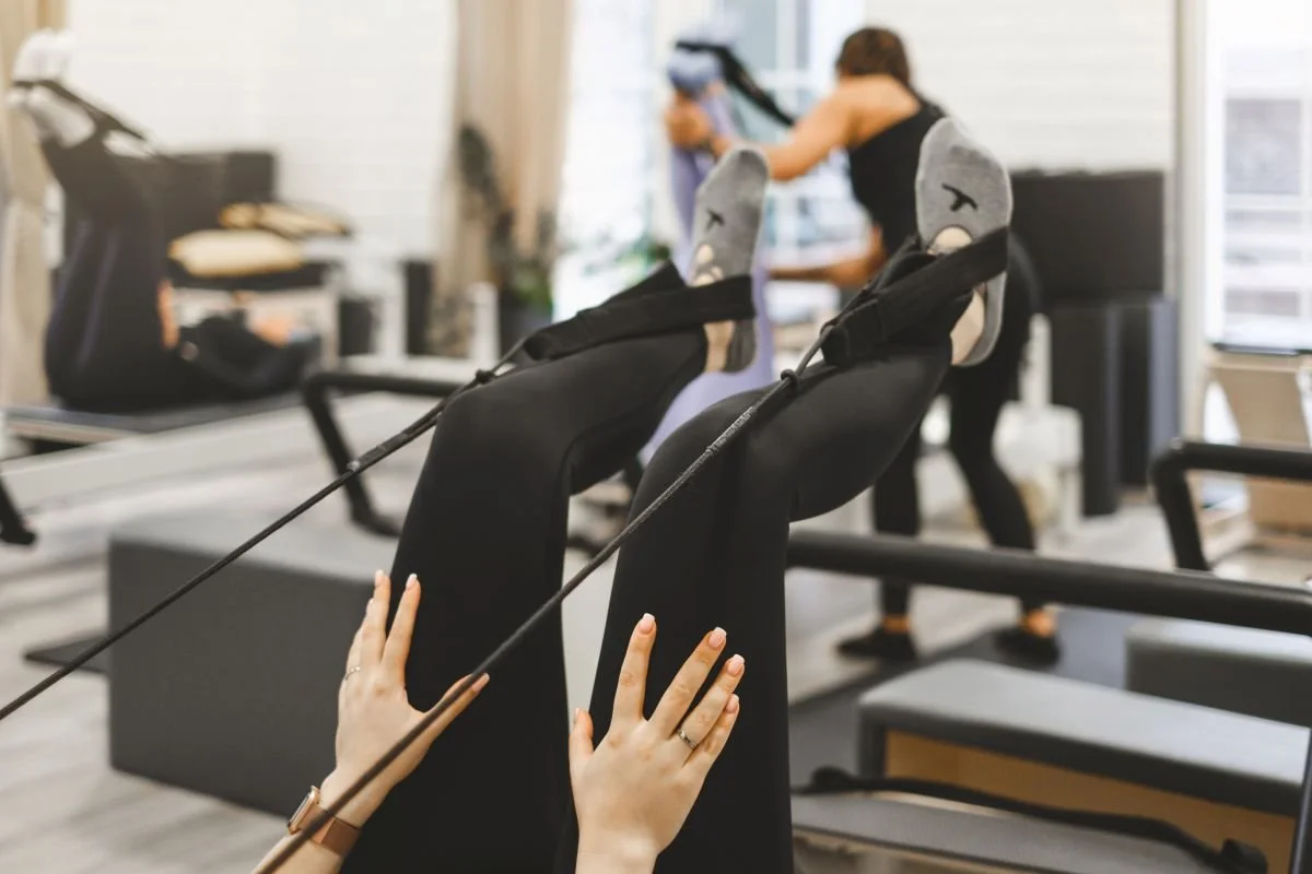 woman doing leg up while practicing pilates