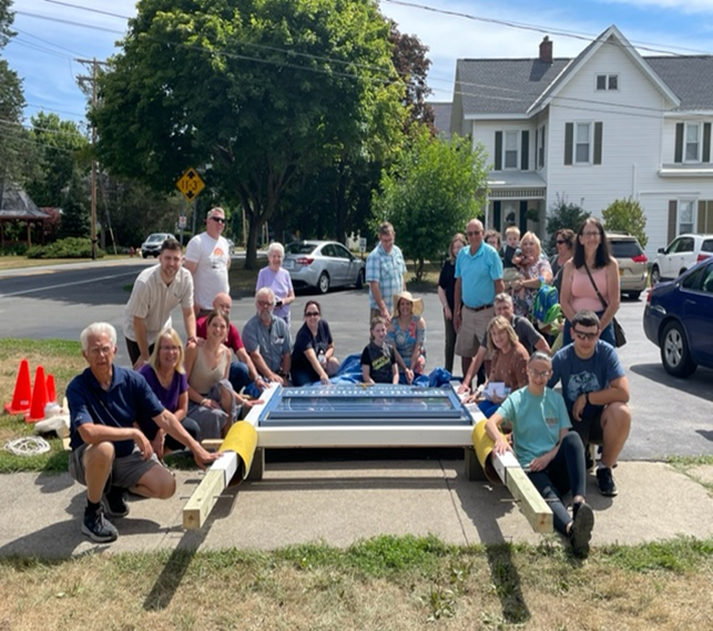 A group of church members raising the new chuch sign