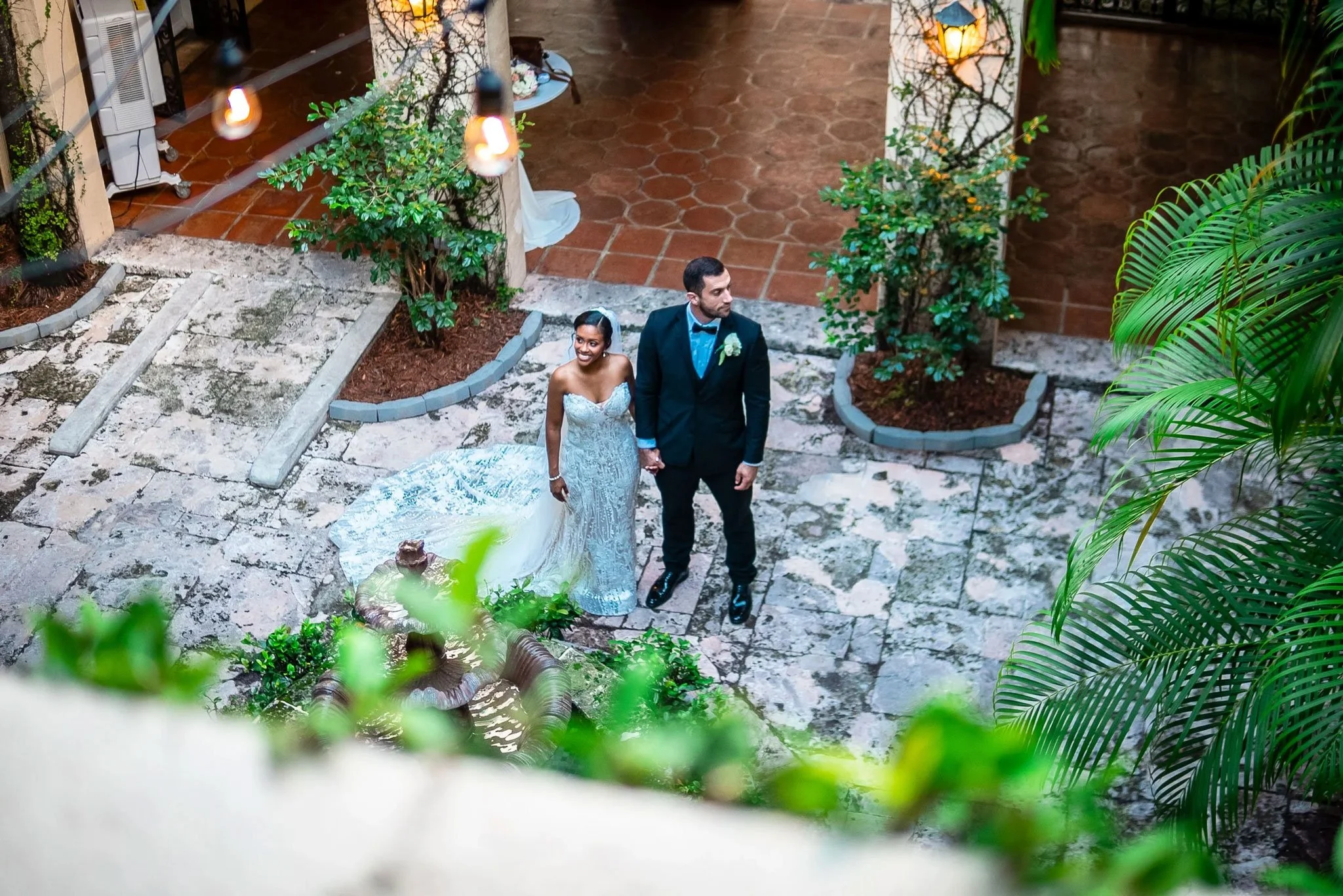 Newlywed couple standing in the tropical courtyard at Villa Woodbine in Miami