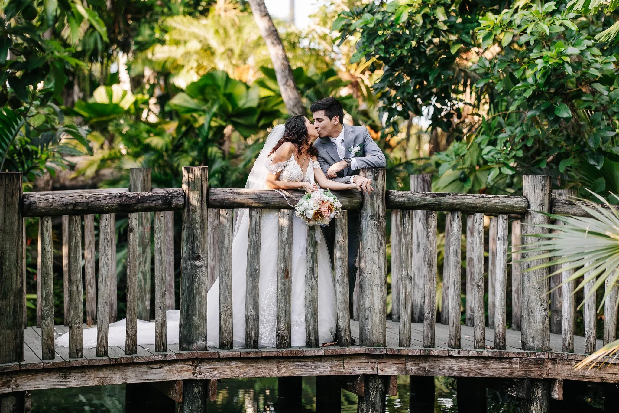Wedding portrait near the bridge and water features at Royal Mansion & Gardens