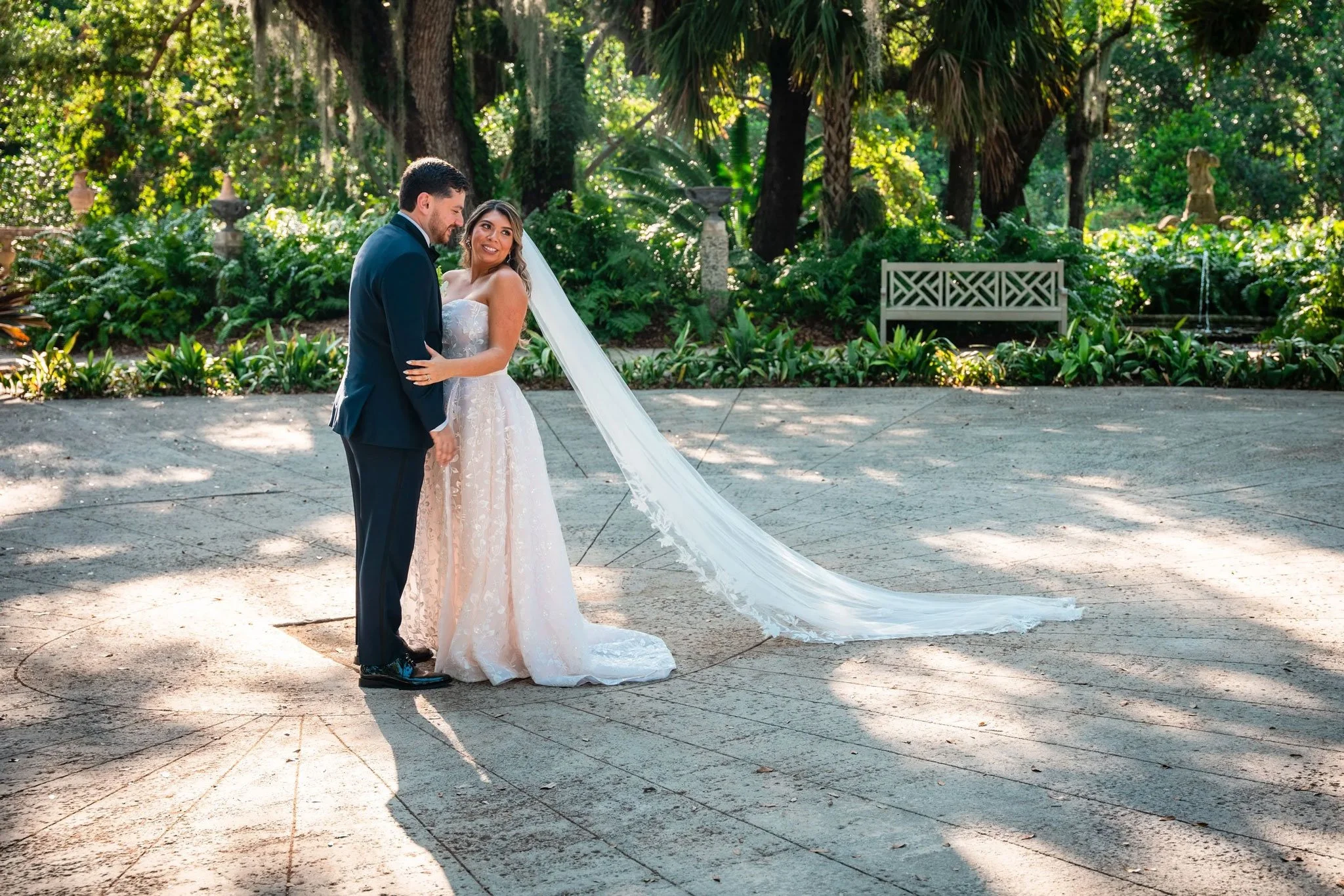 Newly married couple posing in the formal gardens at Vizcaya Museum and Gardens