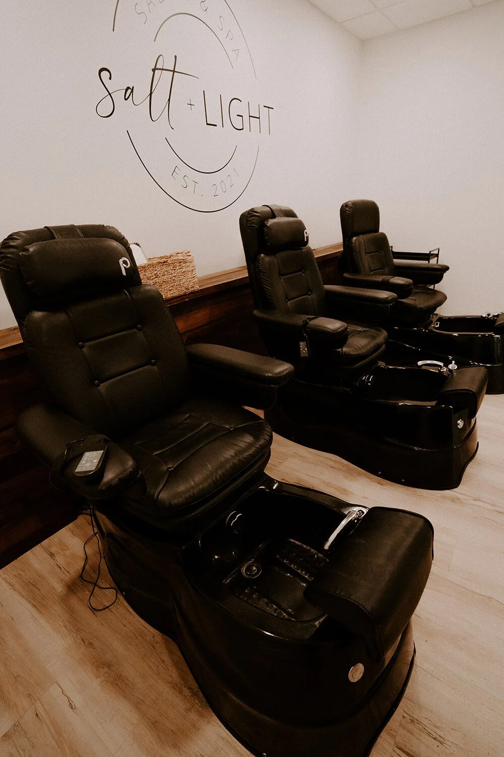 Three black pedicure chairs  at Salt + Light Salon and Spa in Cincinnati, OH