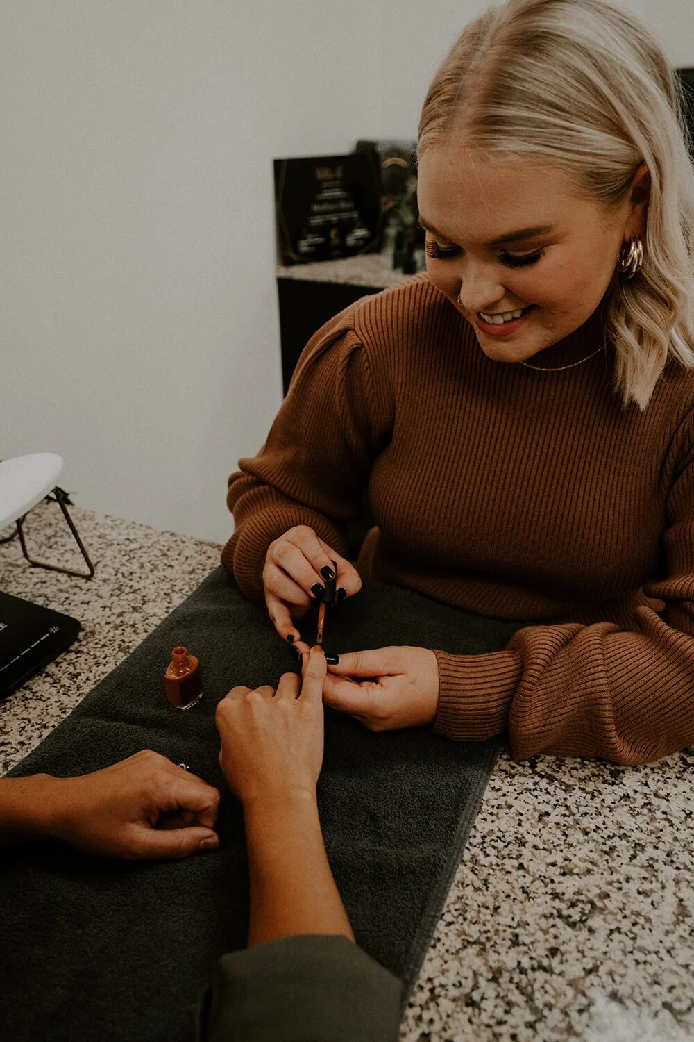 A woman getting a professional manicure at Salt + Light Salon and Spa in Cincinnati, OH.