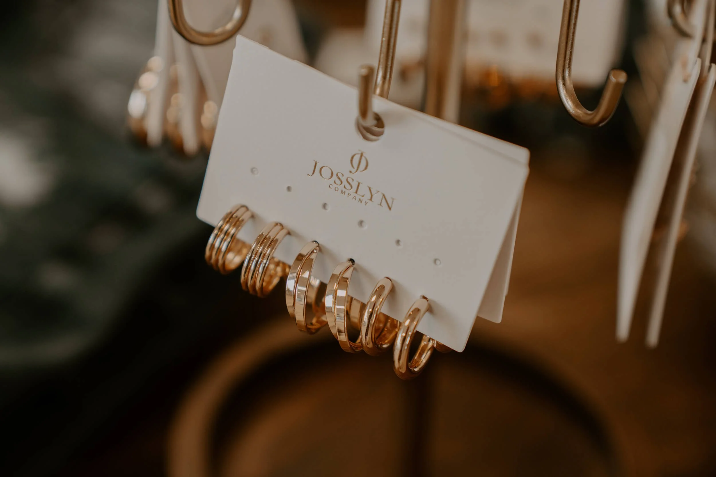 Set of gold rings displayed on a white Josslyn Company card at the Shop Salt boutique.