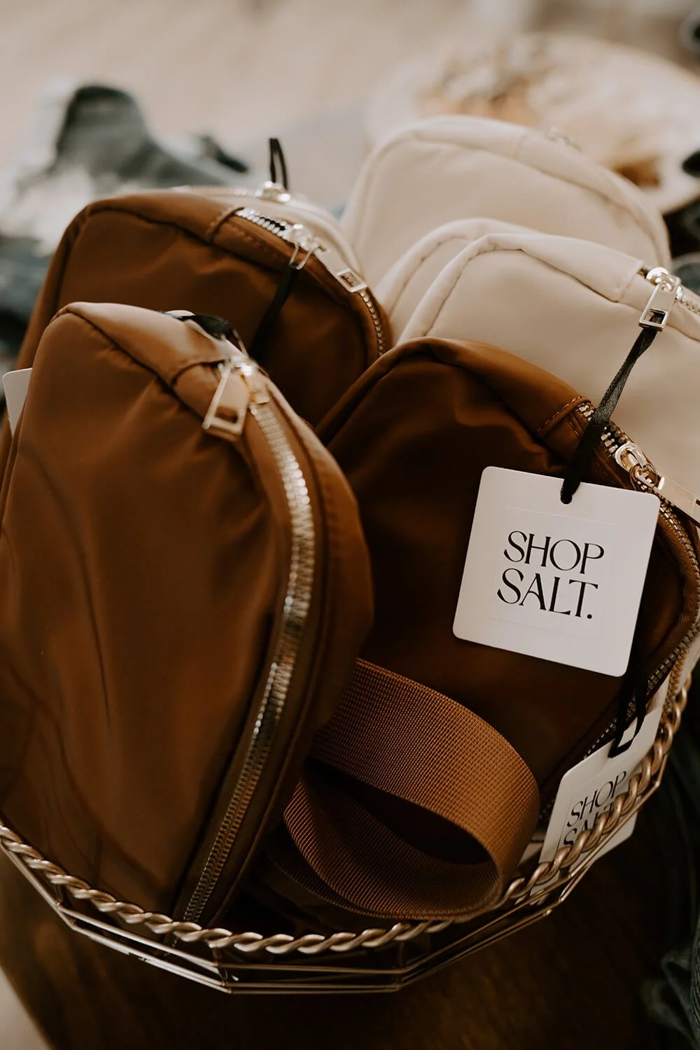 Brown and white bags in a shopping basket with tags that say "Shop Salt".