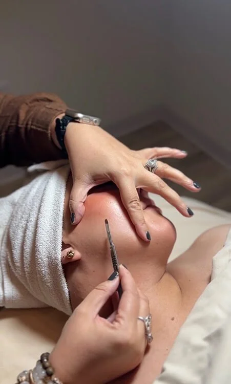 Esthetician doing dermaplaning at Salt + Light Salon and Spa in Cincinnati, Ohio