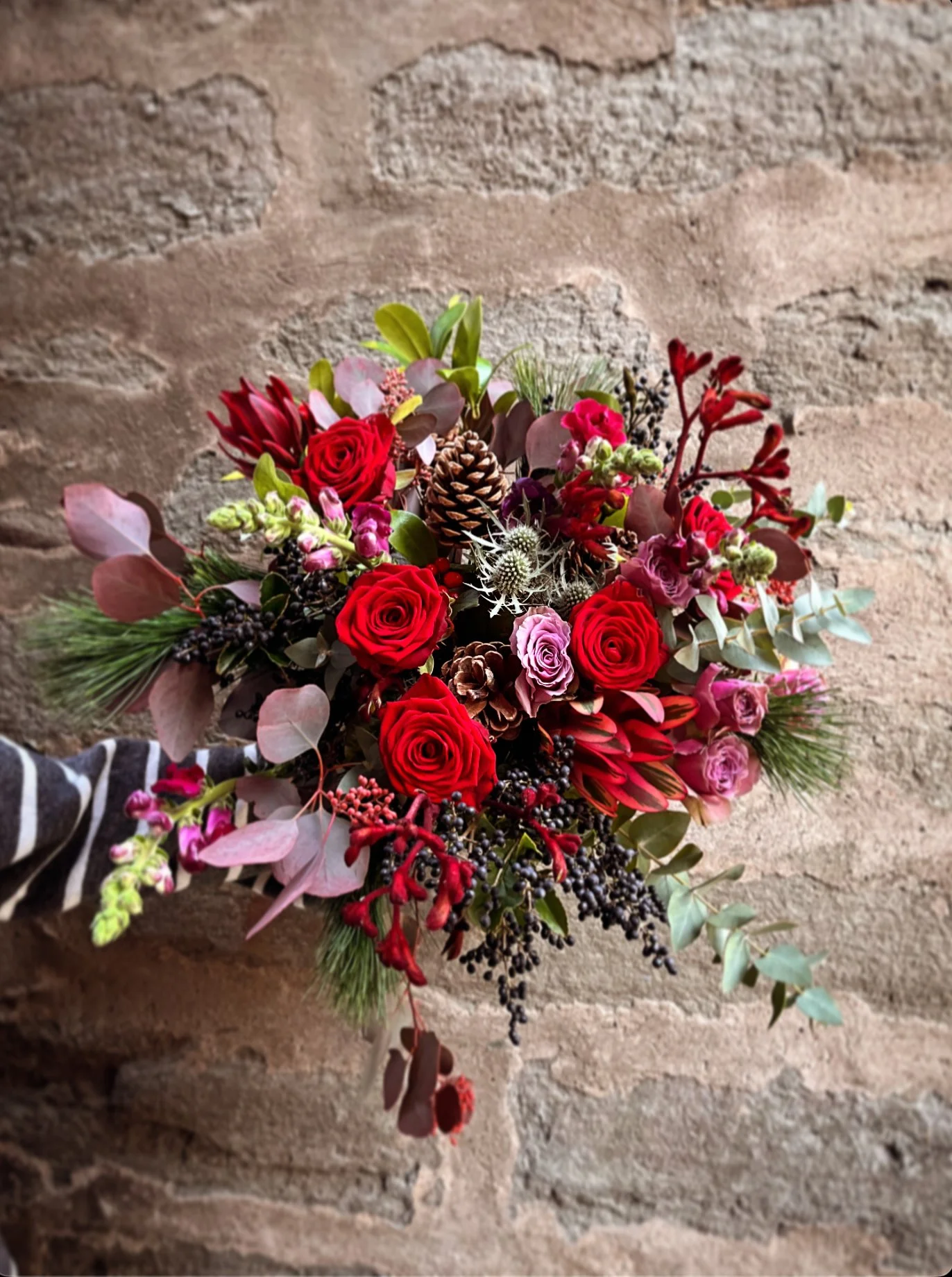 Festive reds Hand tied bouquet