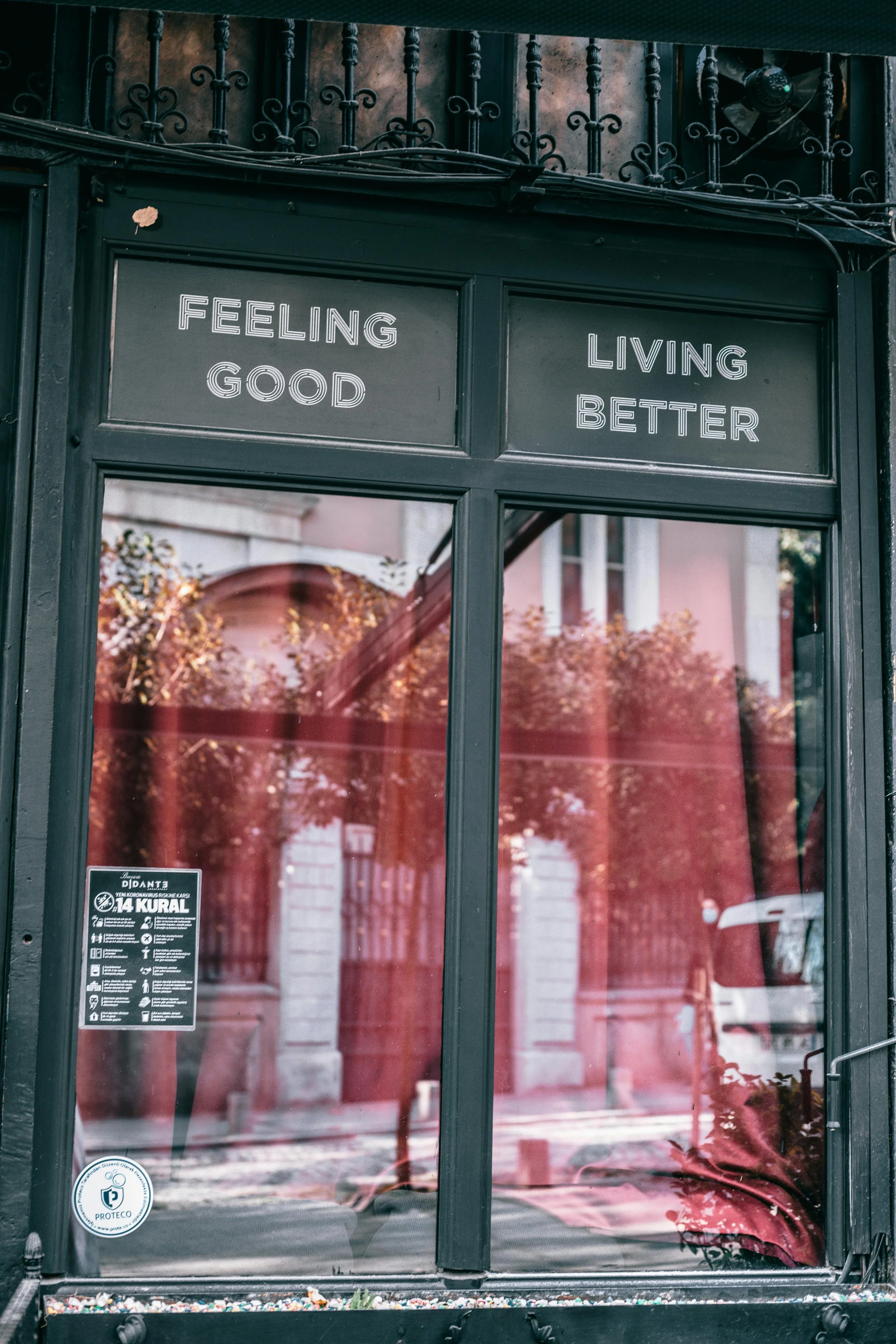 store front window with the words, "Feel Good. Living Better" written above a door