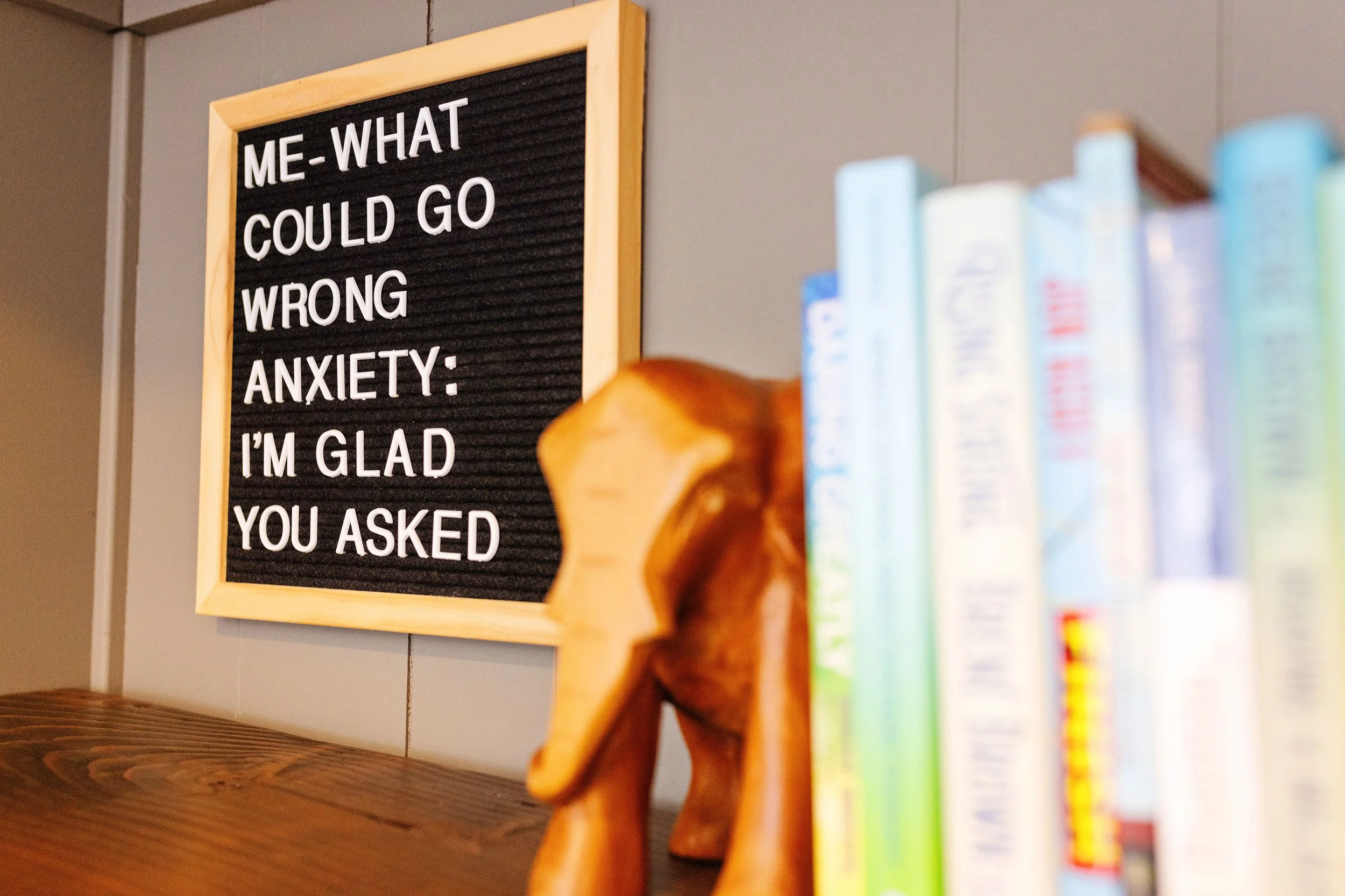 Black letterboard at the end of a row of colorful books