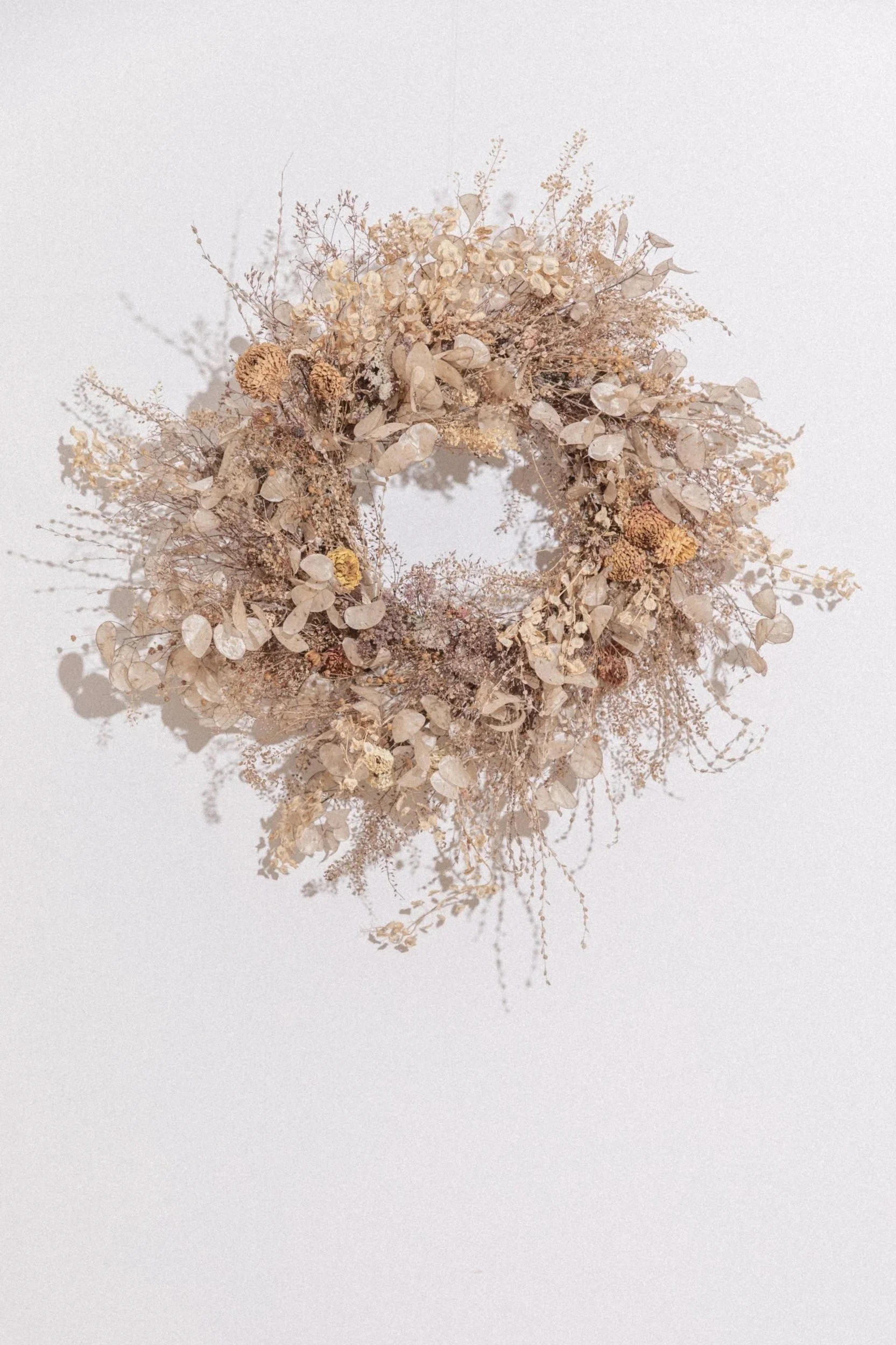 Full moon wreath made with dried flowers, grasses and seedheads at Kokutan flower farm in Devon