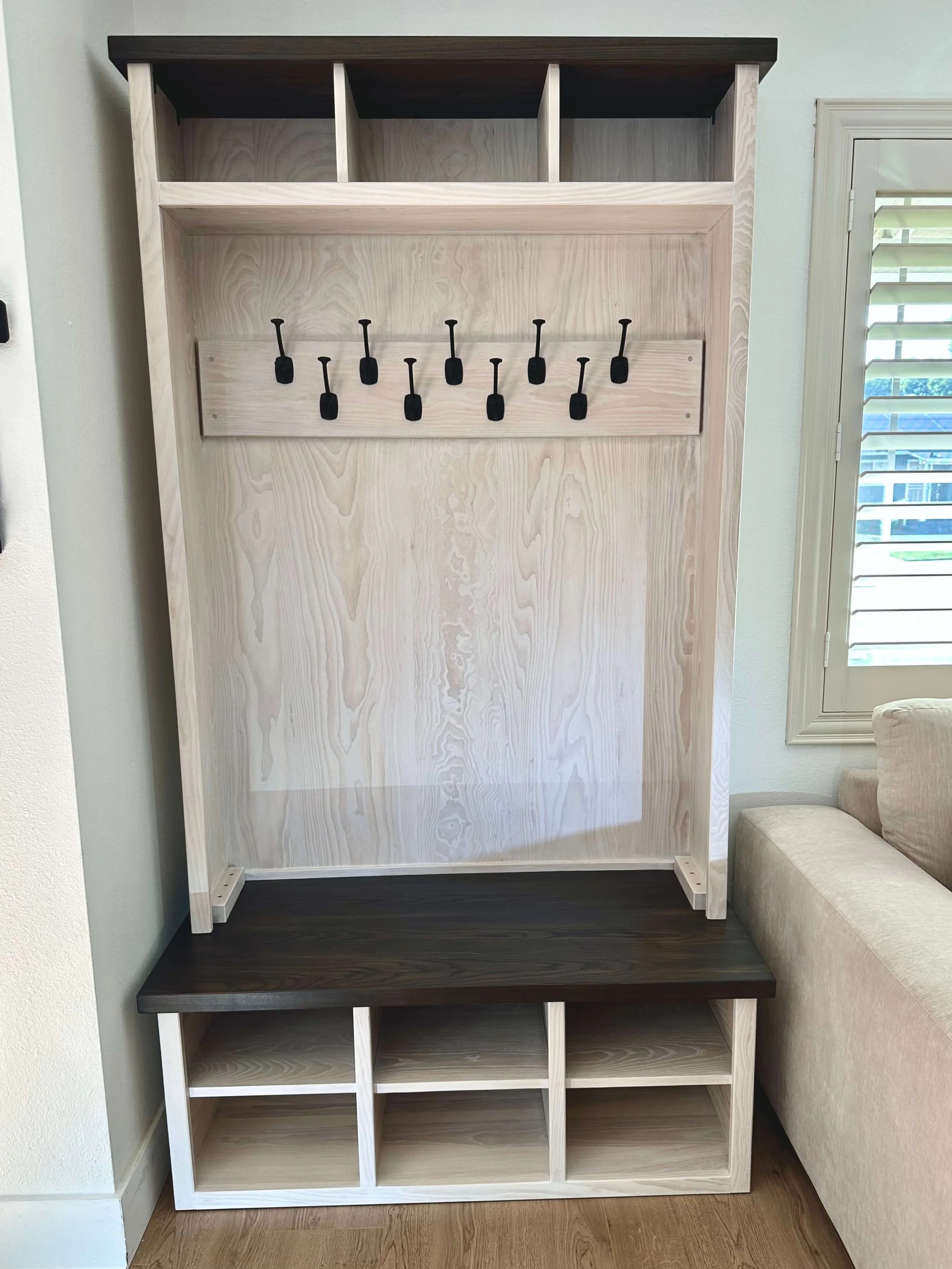 Hall tree with built-in bench and shoe storage.  Made with ash wood and whitewashed.