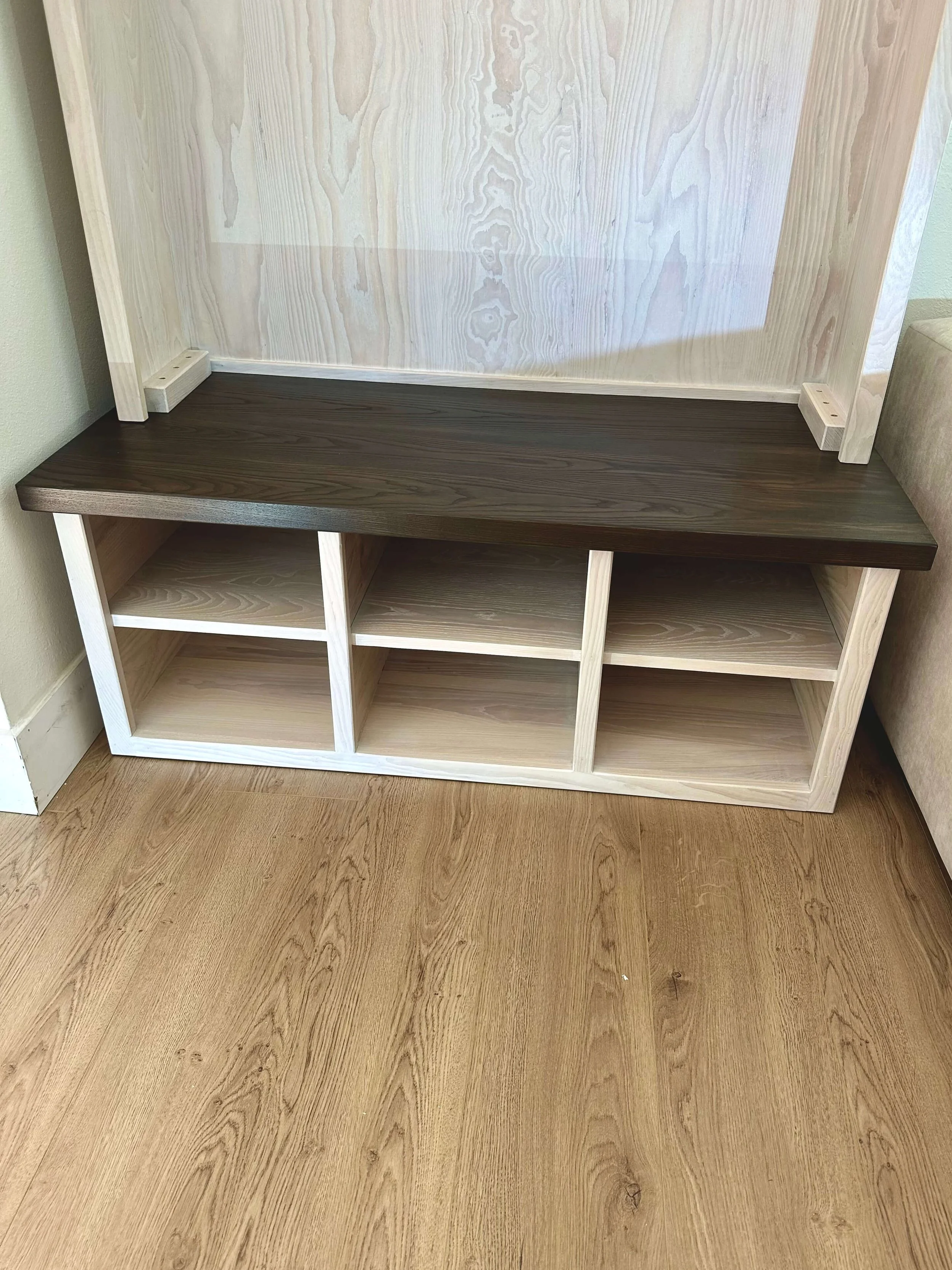 Built-in bench and shoe storage on hall tree.  Made with ash wood and whitewashed.