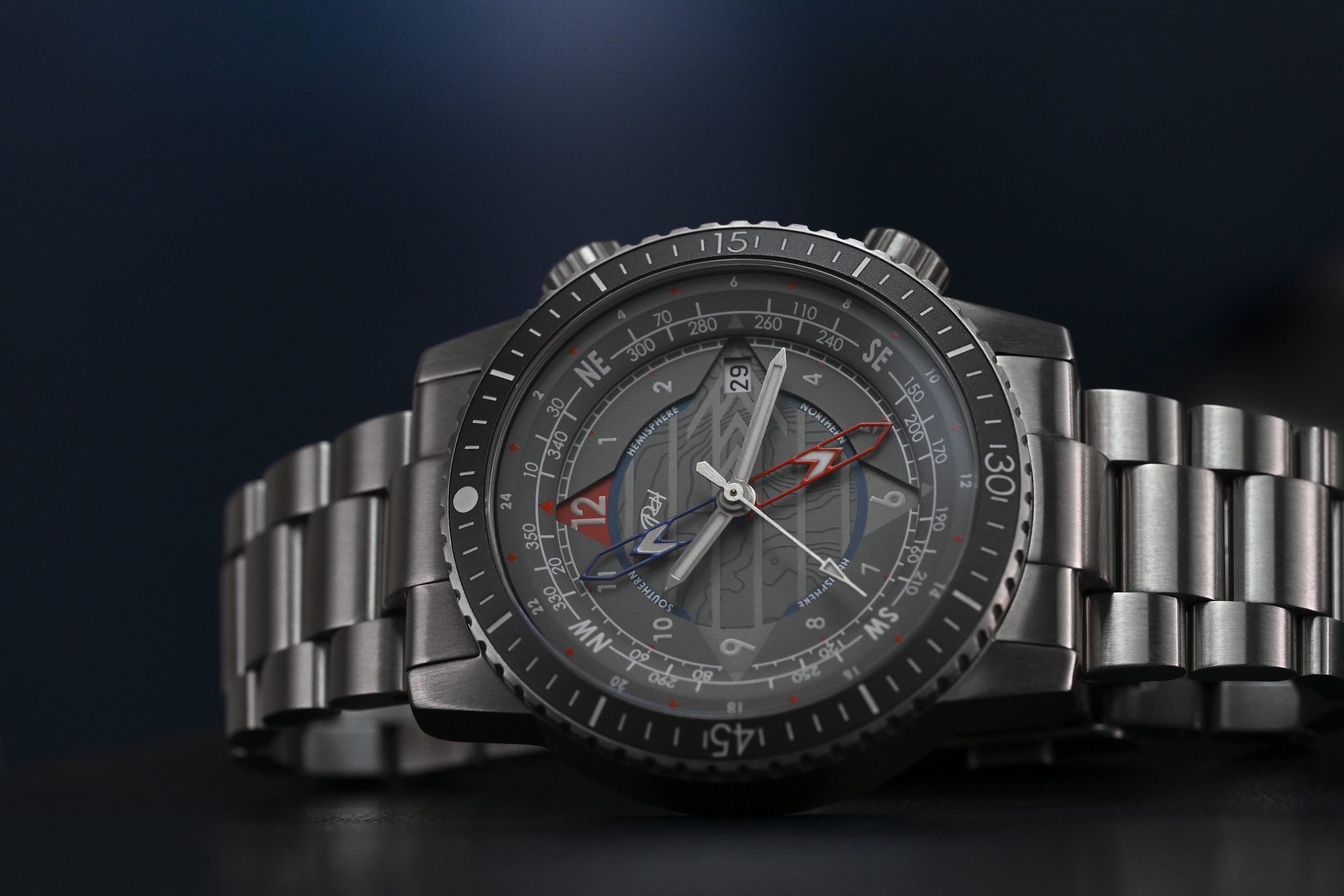Lark watch model with gray dial. GMT, Date, and compass feature, with external bezel timer