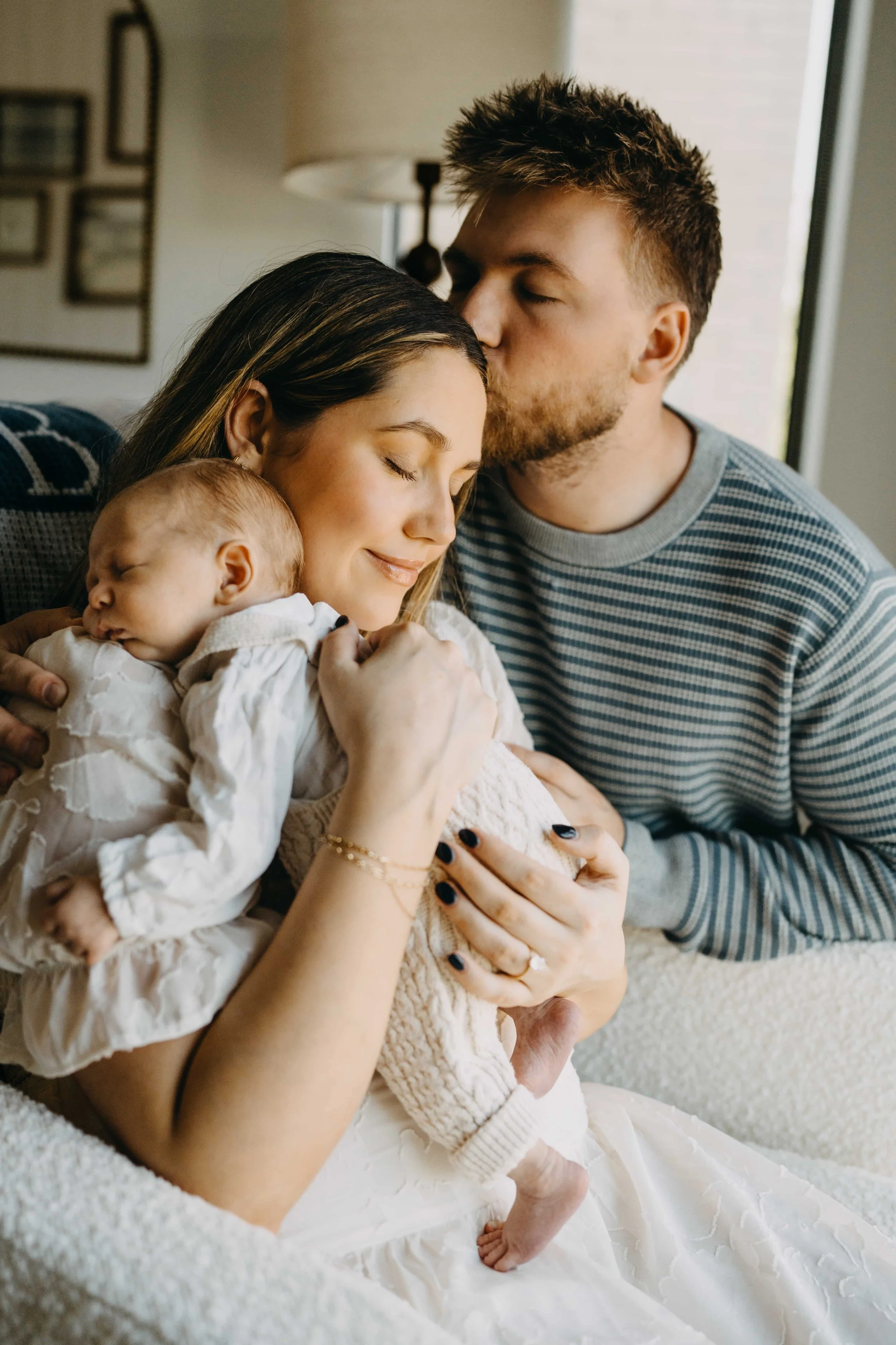 Couple kissing during newborn photoshoot.jpg