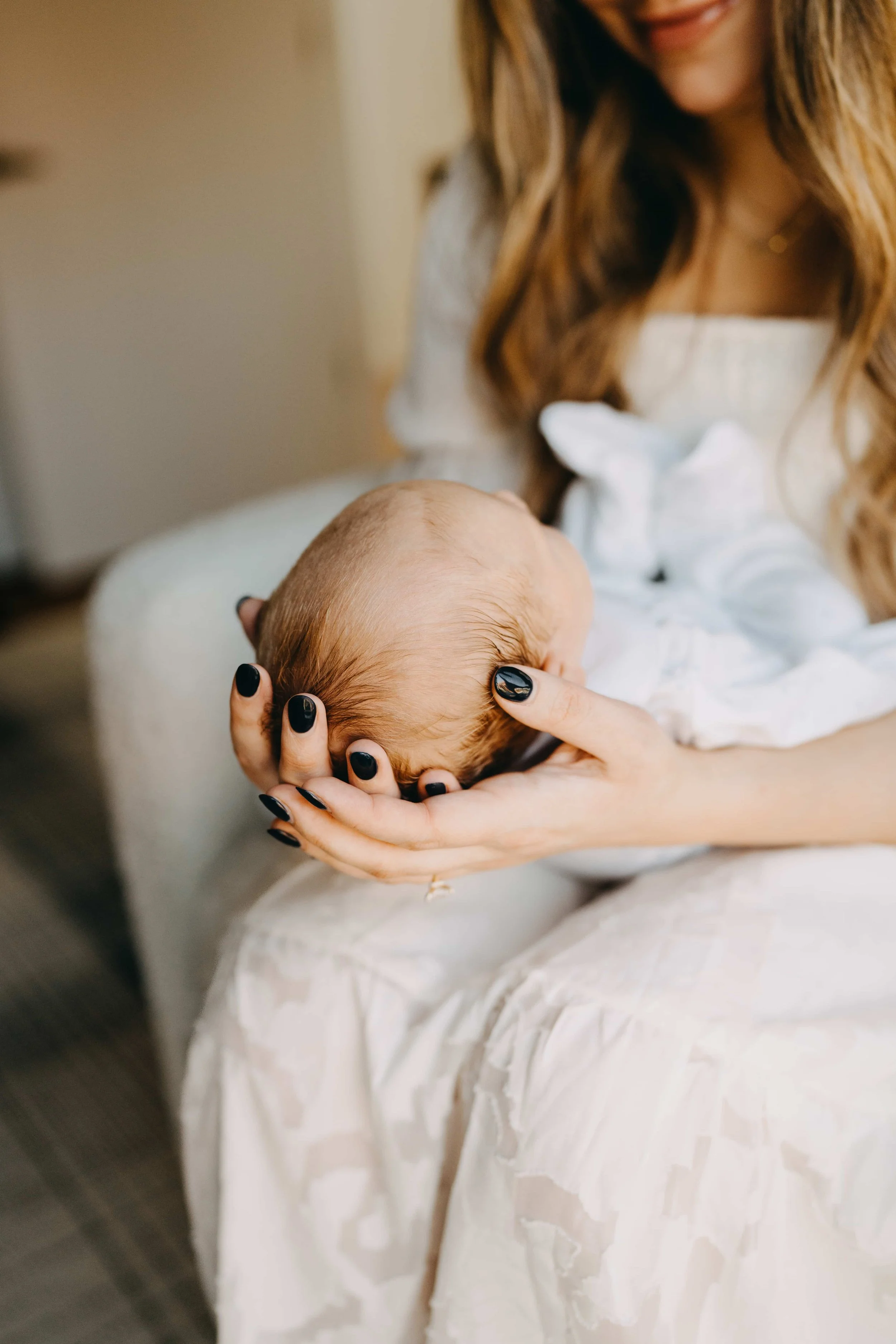 Mother holding newborn in hands.jpg