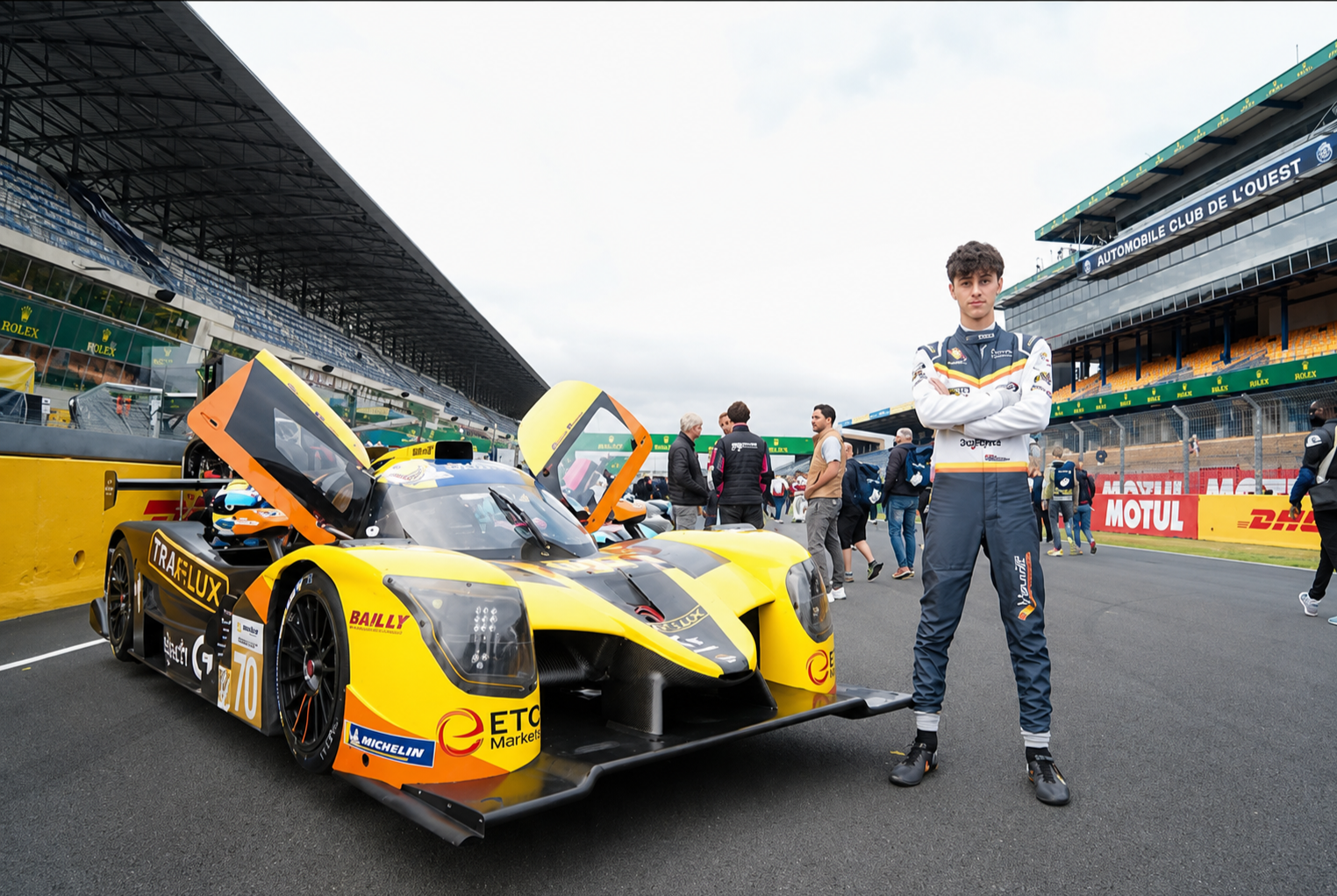 Jude Peters standing with his #70 yellow Virage Racing LMP3. It ws photograhphed on pit road of Circuit de la Sarthe