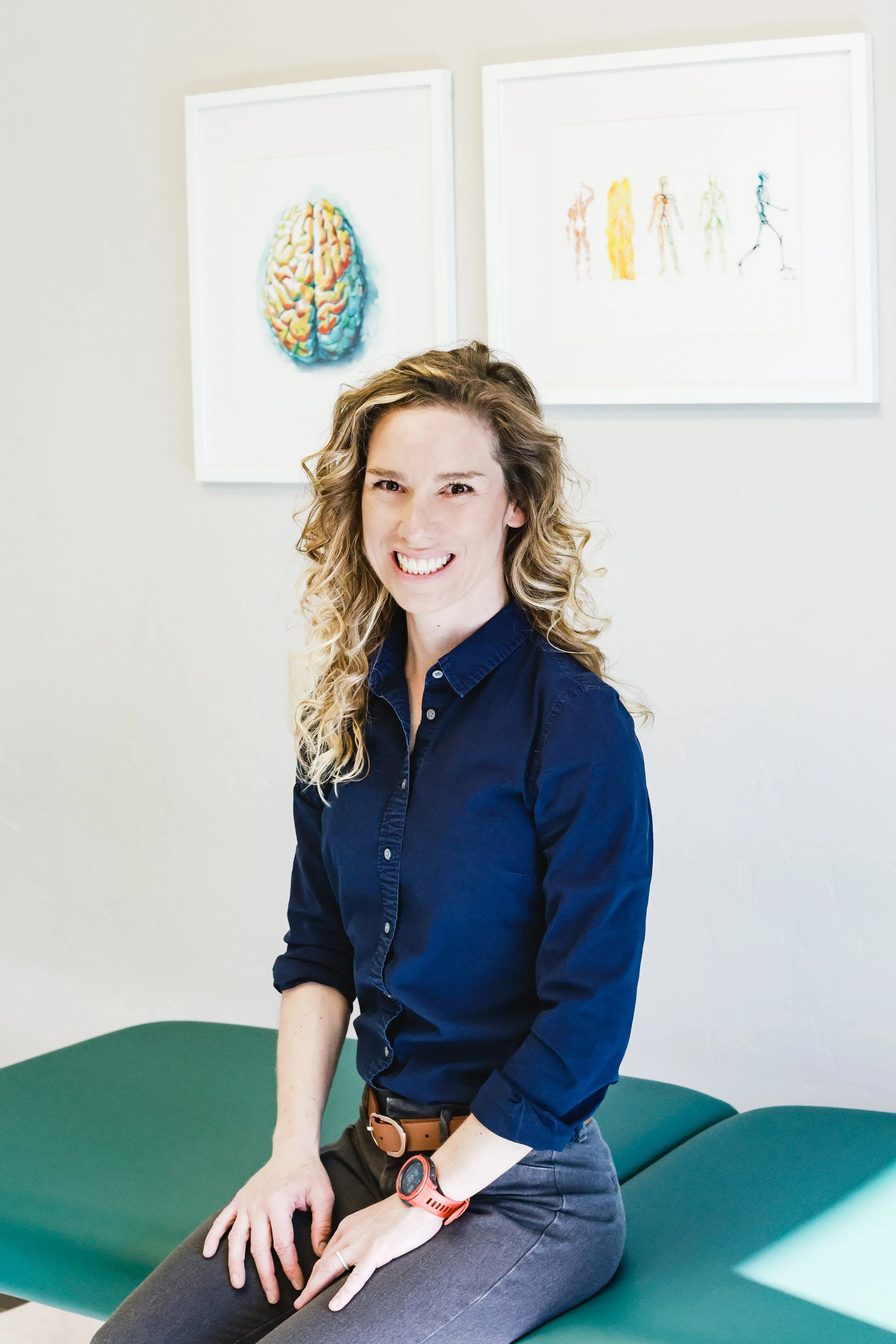 Physical therapist Jessie Duppler smiling at a camera at her physical therapy clinic.