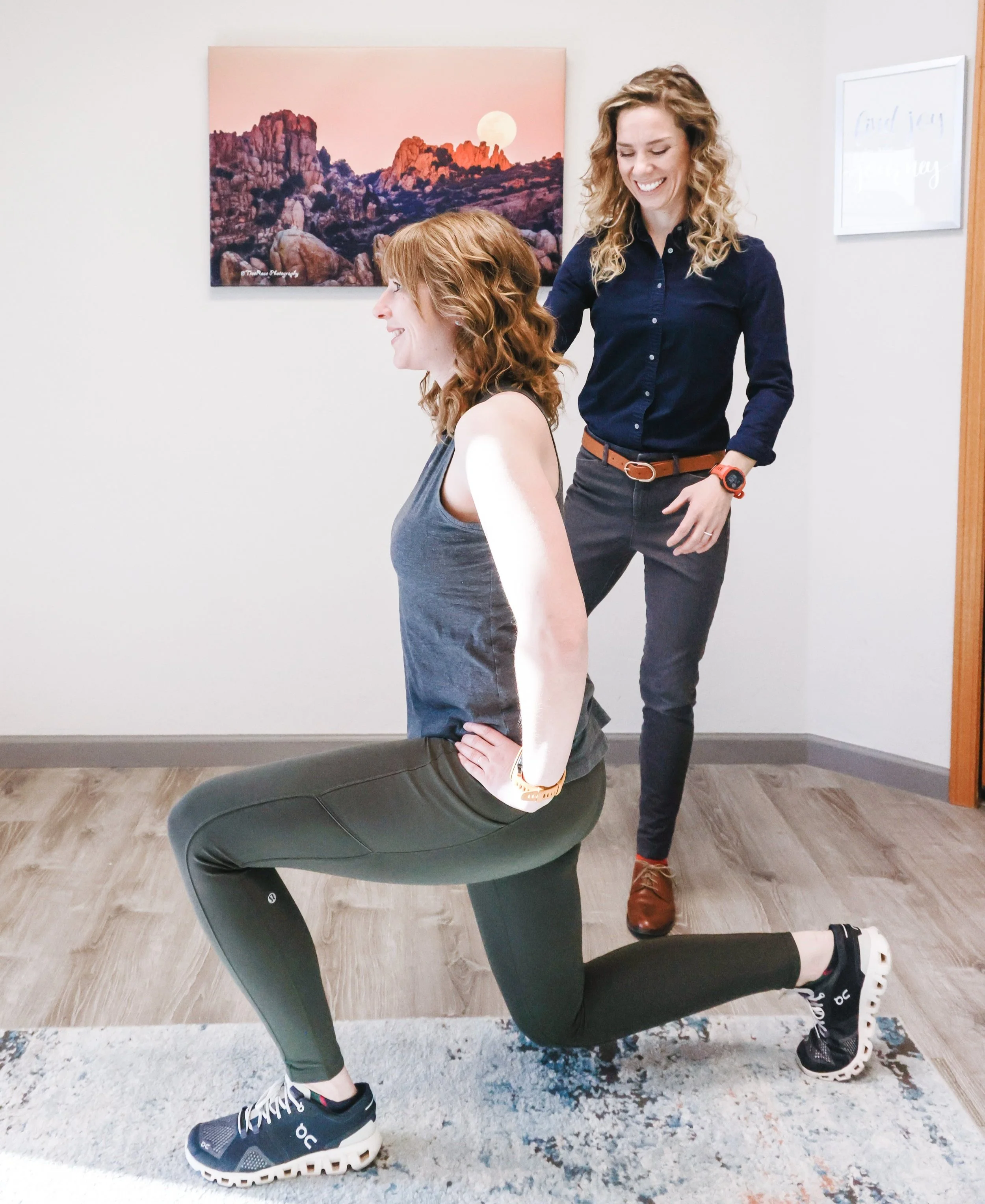 Physical therapist working with a client at a physical therapy clinic performing lunges and strength training.
