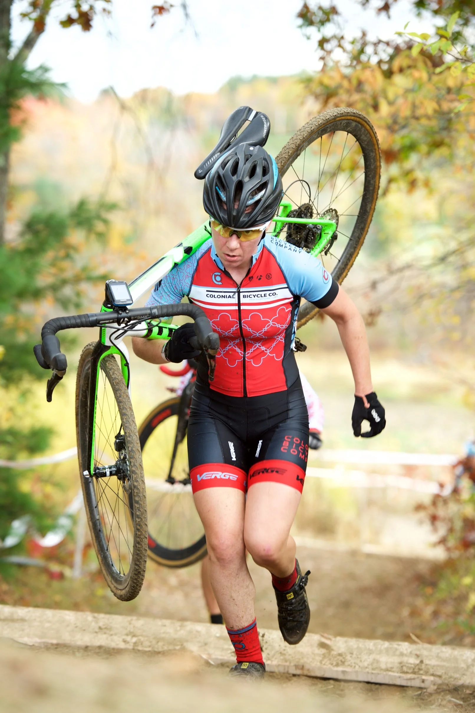 Jessie Dupler, a cycling-specific physical therapist, carrying her bike when she was a competitive cyclist.