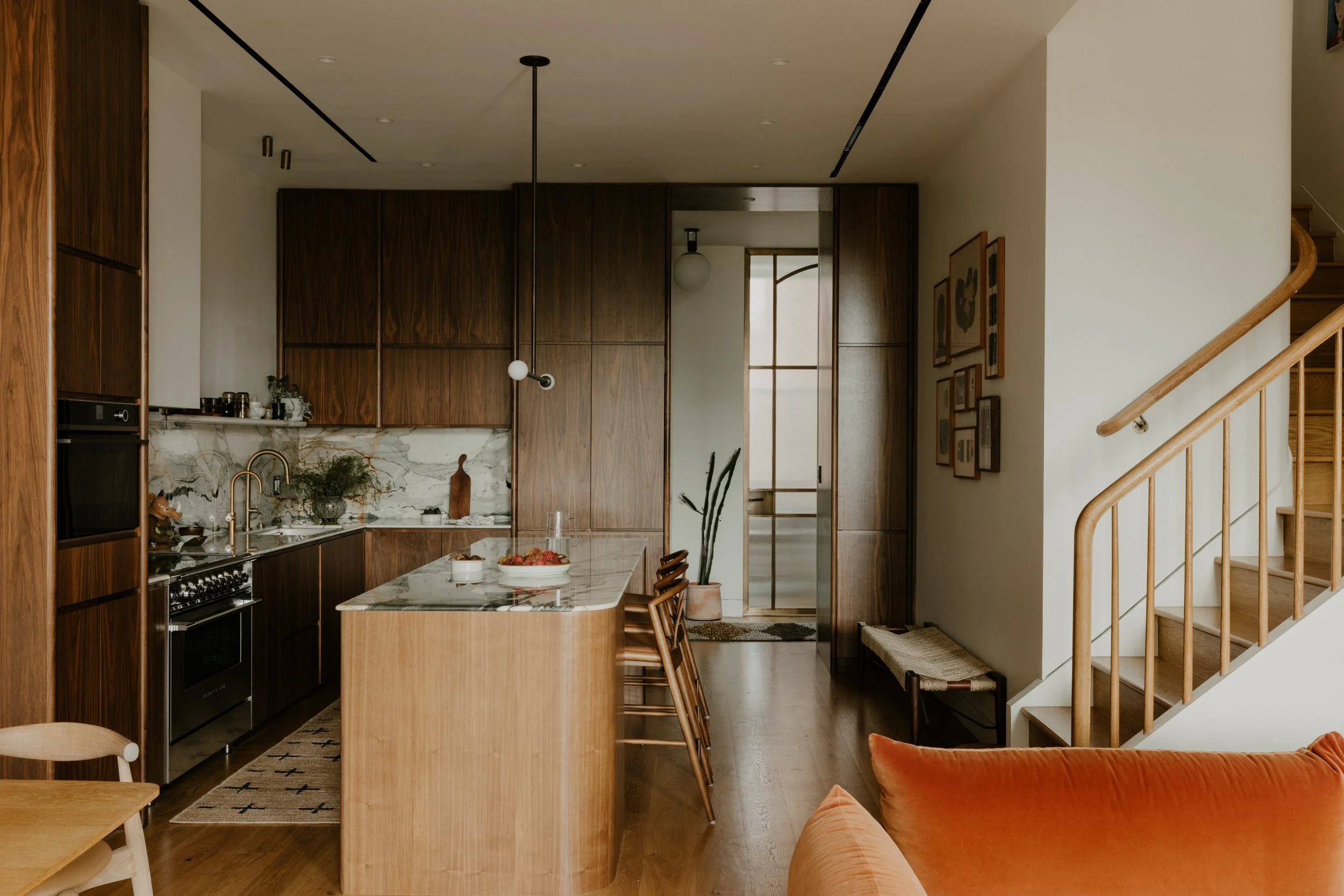 The kitchen millwork was designed to absorb their storage needs while reseeding into the background