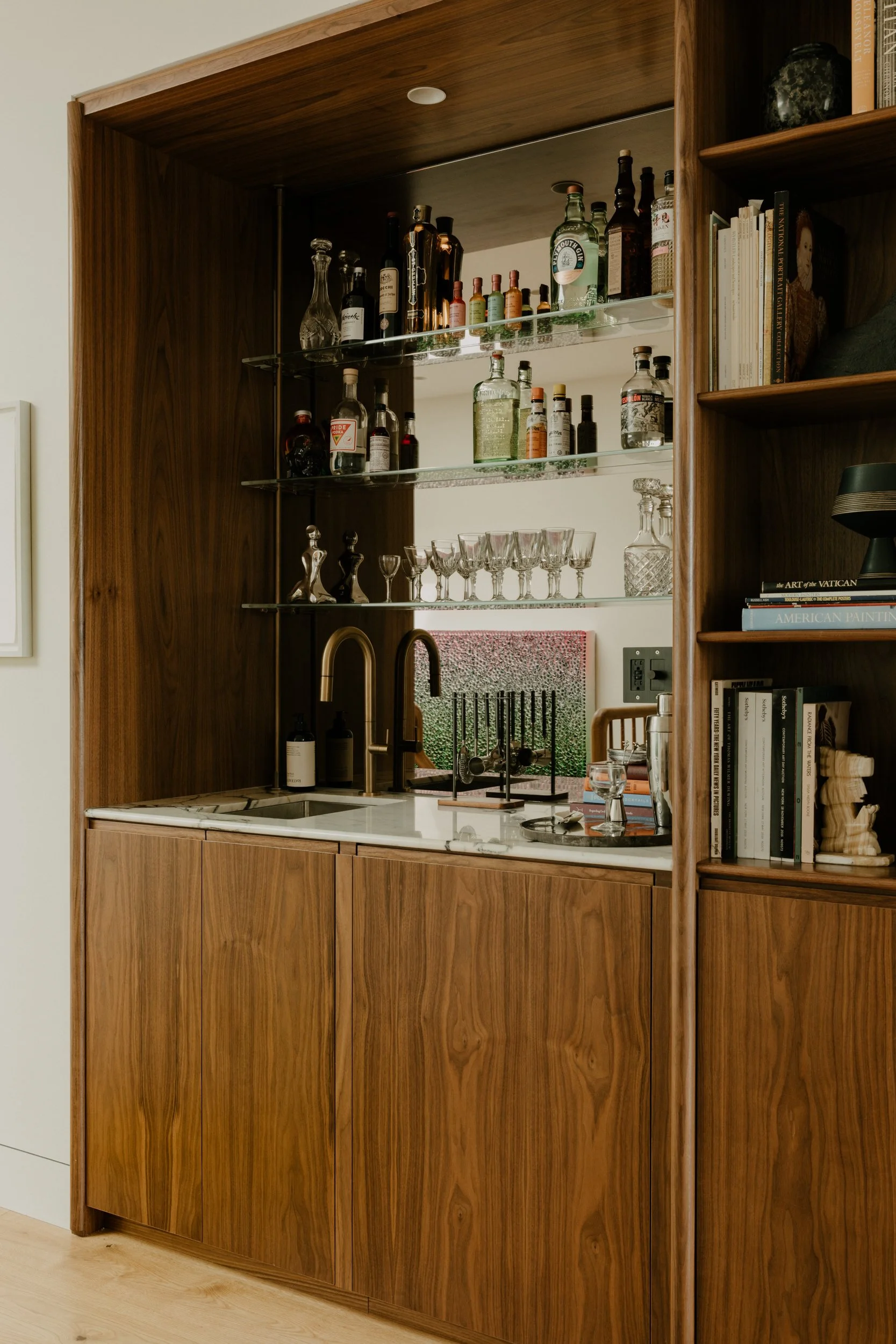 A custom wet bar contains a convenient undercounted refrigerator and a coffee machine.