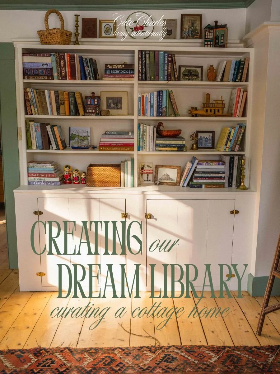 background is a colourful whimsical bookshelf styled with antiques, baskets, colourful books, and nautical items; text overlay reads "creating our dream library, curating a cottage home.'