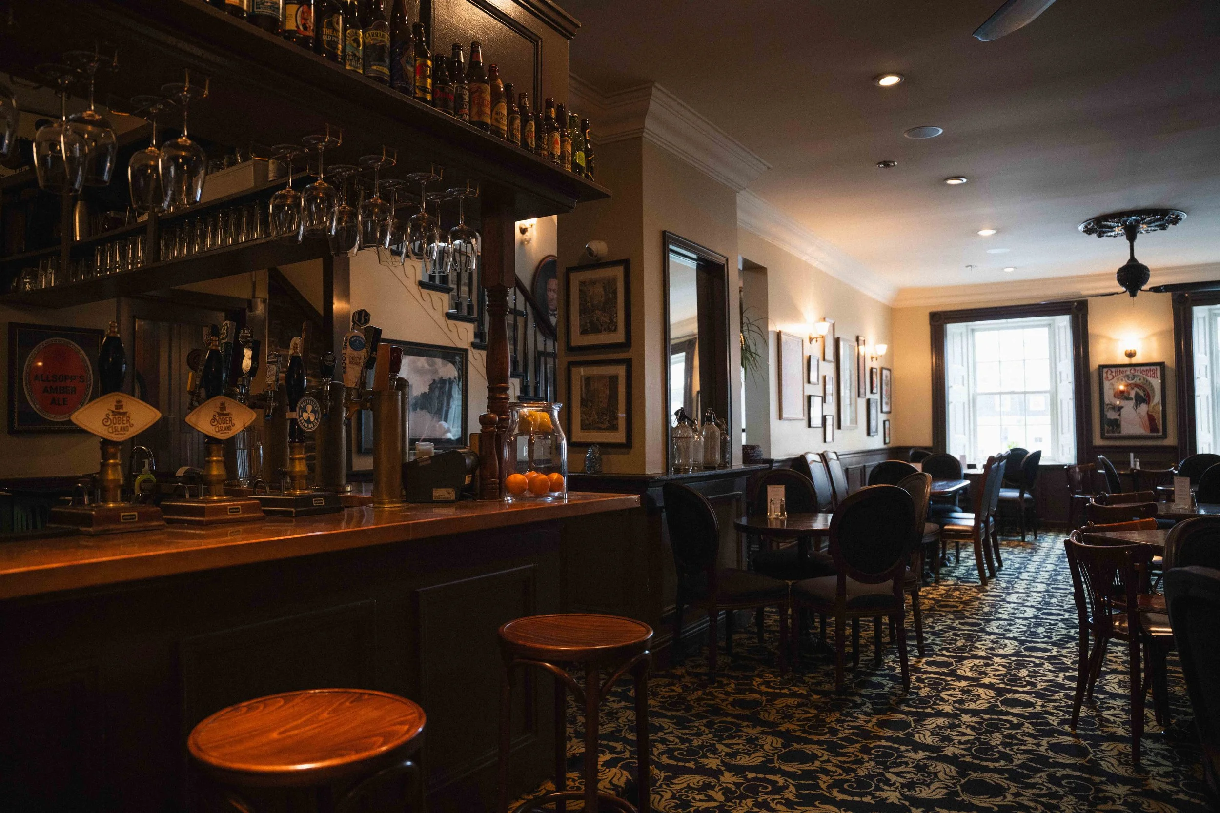 inside a historic pub building dining room with a wooden bar, a guide to cozy spaces in Halifax, Nova Scotia. Henry House