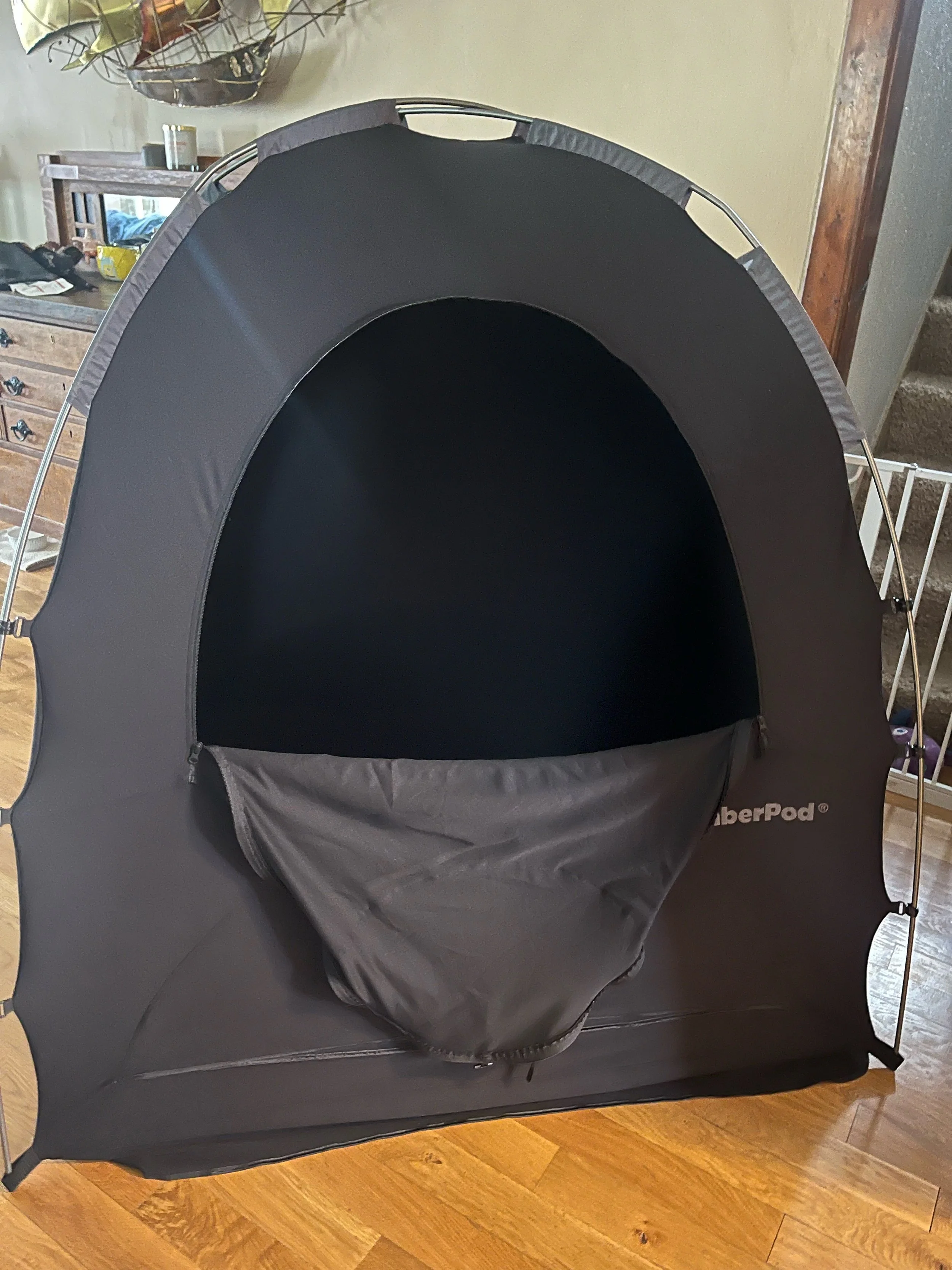 SlumberPod tent unzipped. This is perfect to privide darkness and separation when sharing rooms or in a new environment. Pair with a mini crib or pack n play, baby monitor and sound machine.