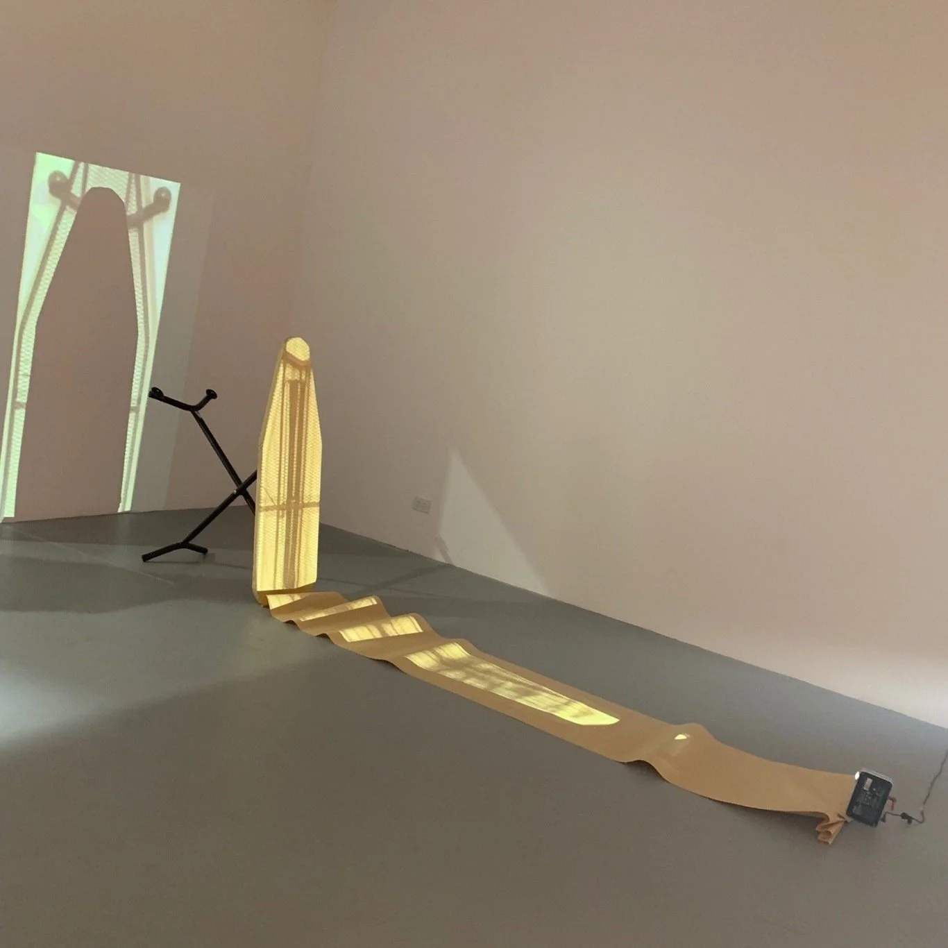 In crease/Im press, found ironing board, butchers paper, projected video, 2019