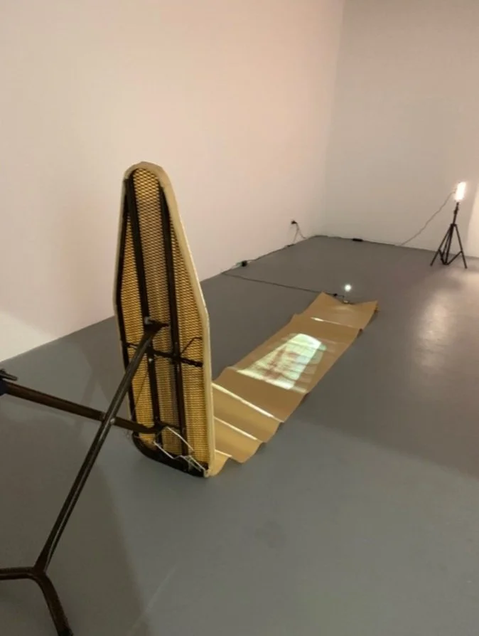 In crease/Im press, found ironing board, butchers paper, projected video, 2019