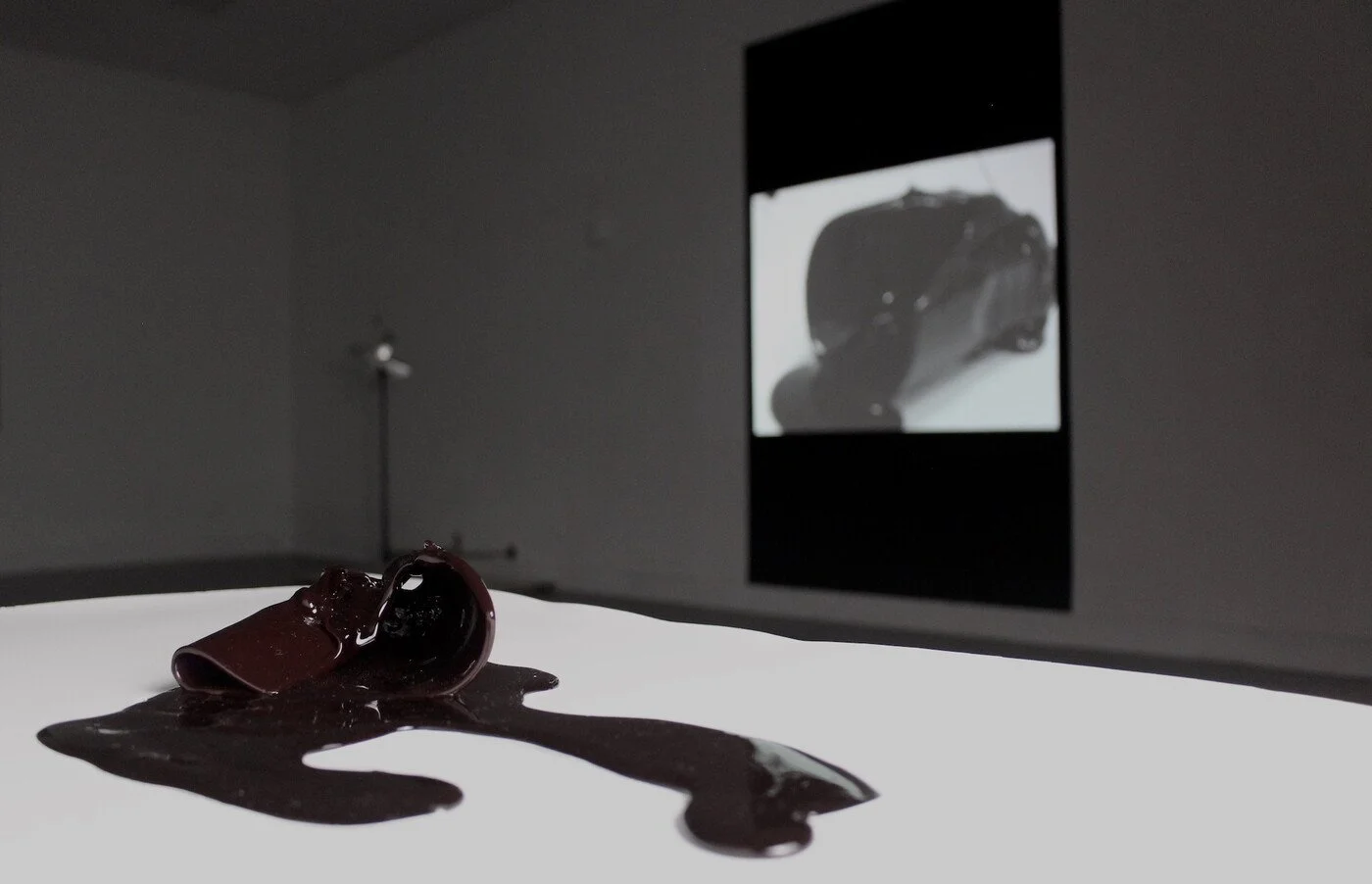 To Sip from the Sweet Cup (swallow the lump of illusion, spit yourself out in shards), Sugar glass, photography roll and light, square steel structure, single-channel video, black paint, 2021