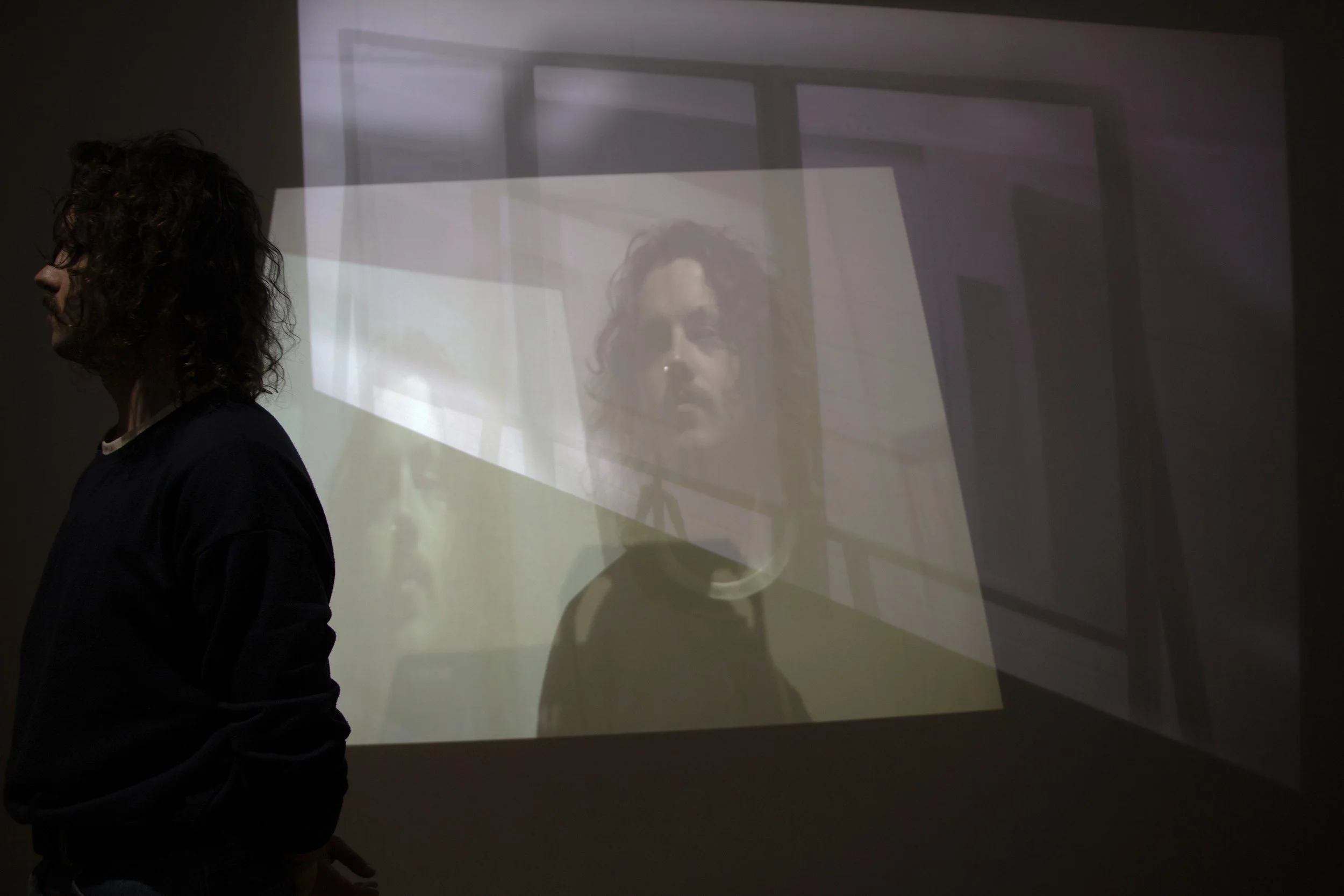 'In Frame', pinewood, glass panels, two-way mirrored film, livestream camera, pre-recorded video, projection, 'INT.',  Green Floor Gallery, 2024