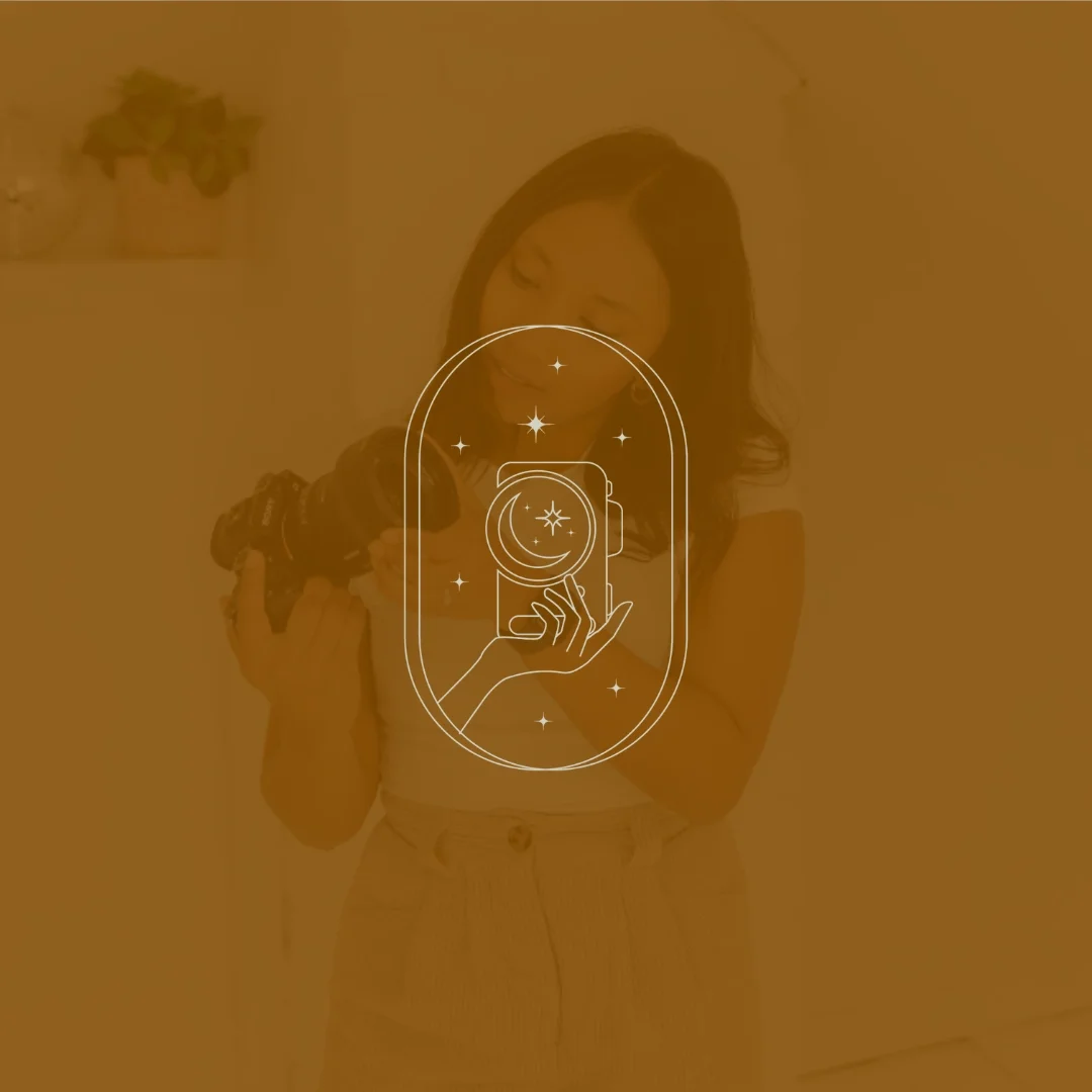 A woman is holding a camera and looking down while smiling, with an internal graphic of a camera and a mirror framed by stars overlayed on the image.
